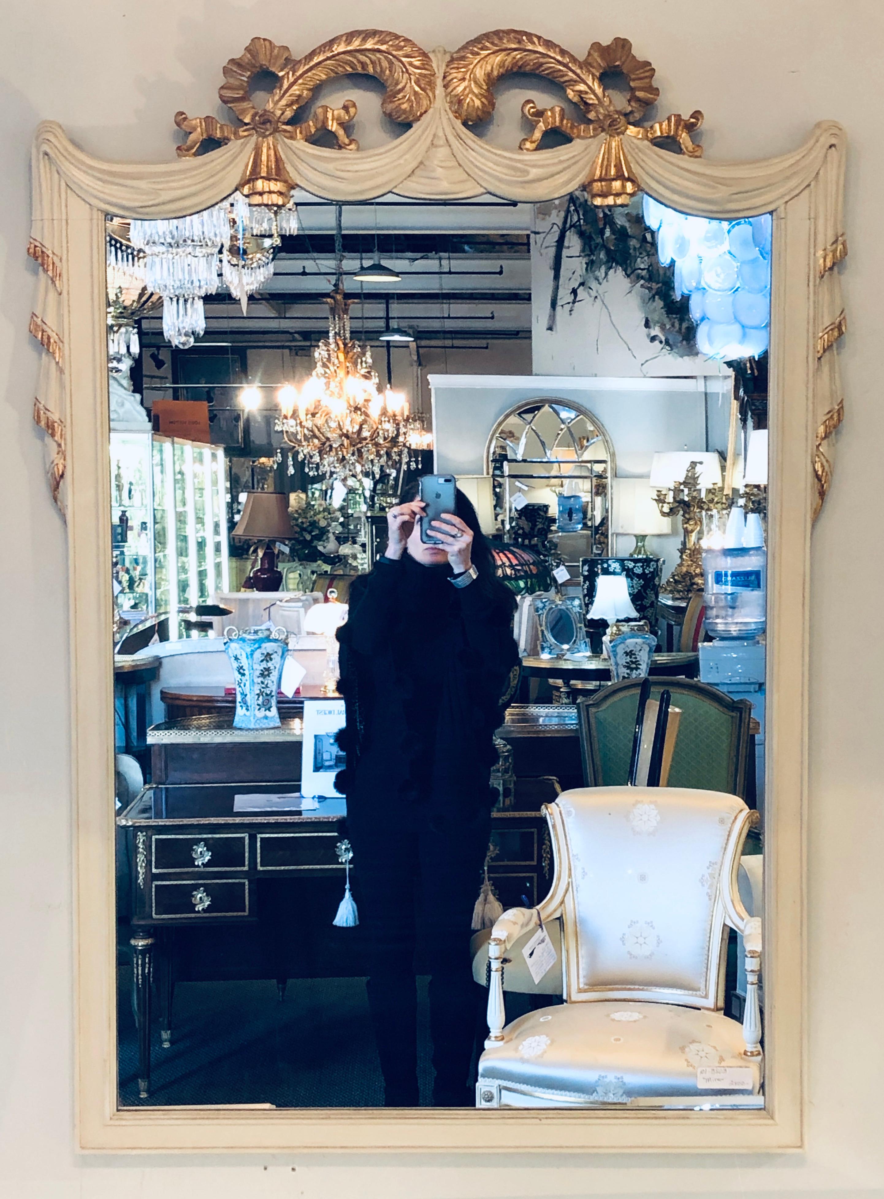 Hollywood Regency Grosfeld House painted vanity and matching mirror. In a word Magnificent. This recently decorated linen white desk or vanity by Grosfeld House has a matching mirror. The overall off white slighted aged finish with clay under the