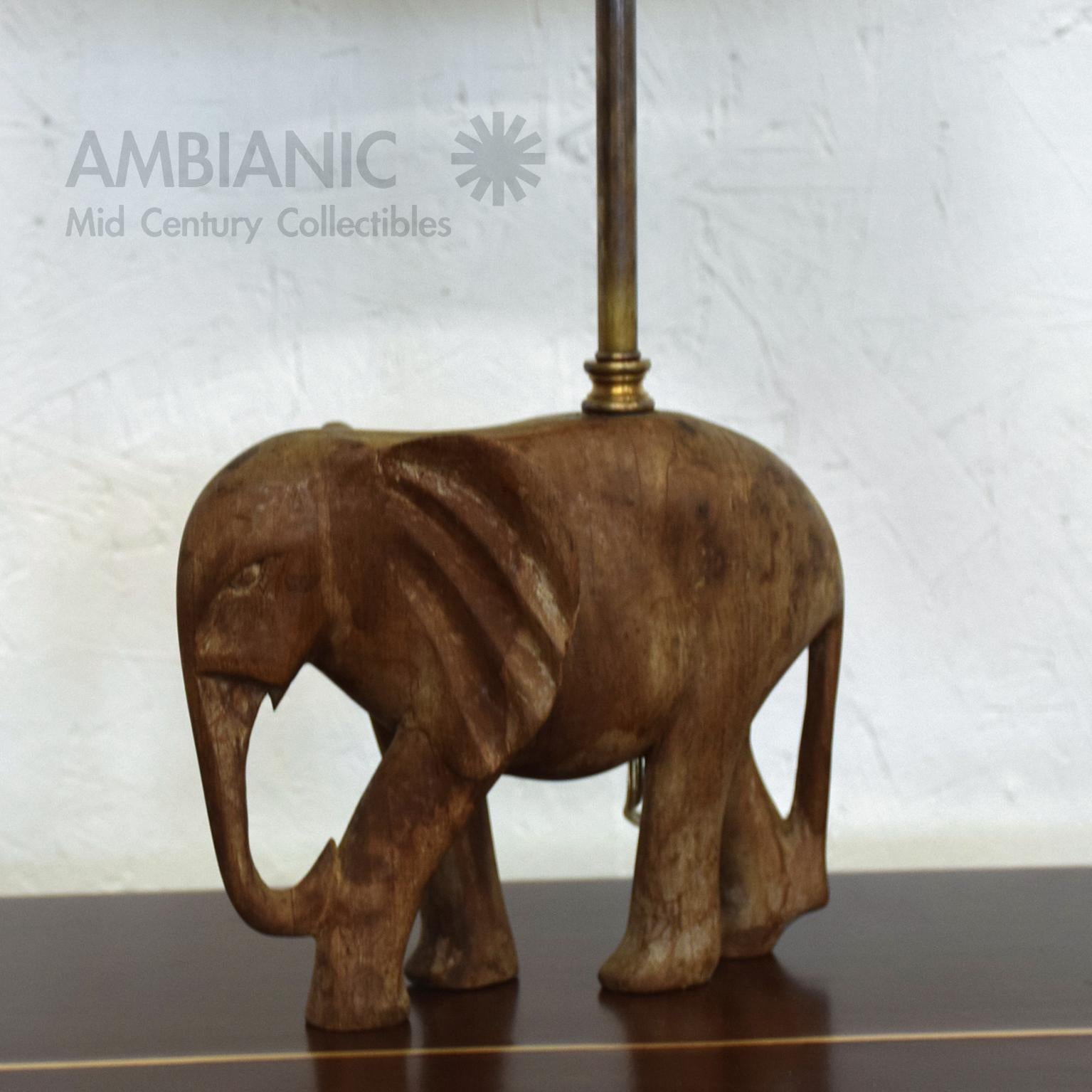 Table Lamp
Hand Carved Wood Elephant Sculpture Table Lamp circa 1950s.
In the style of James Mont and Maitland Smith.
18.38 x 9.5 W x 5 D.
Original Unrestored Vintage Preowned Fair Condition. Patinated Wood appears to be walnut retaining its
