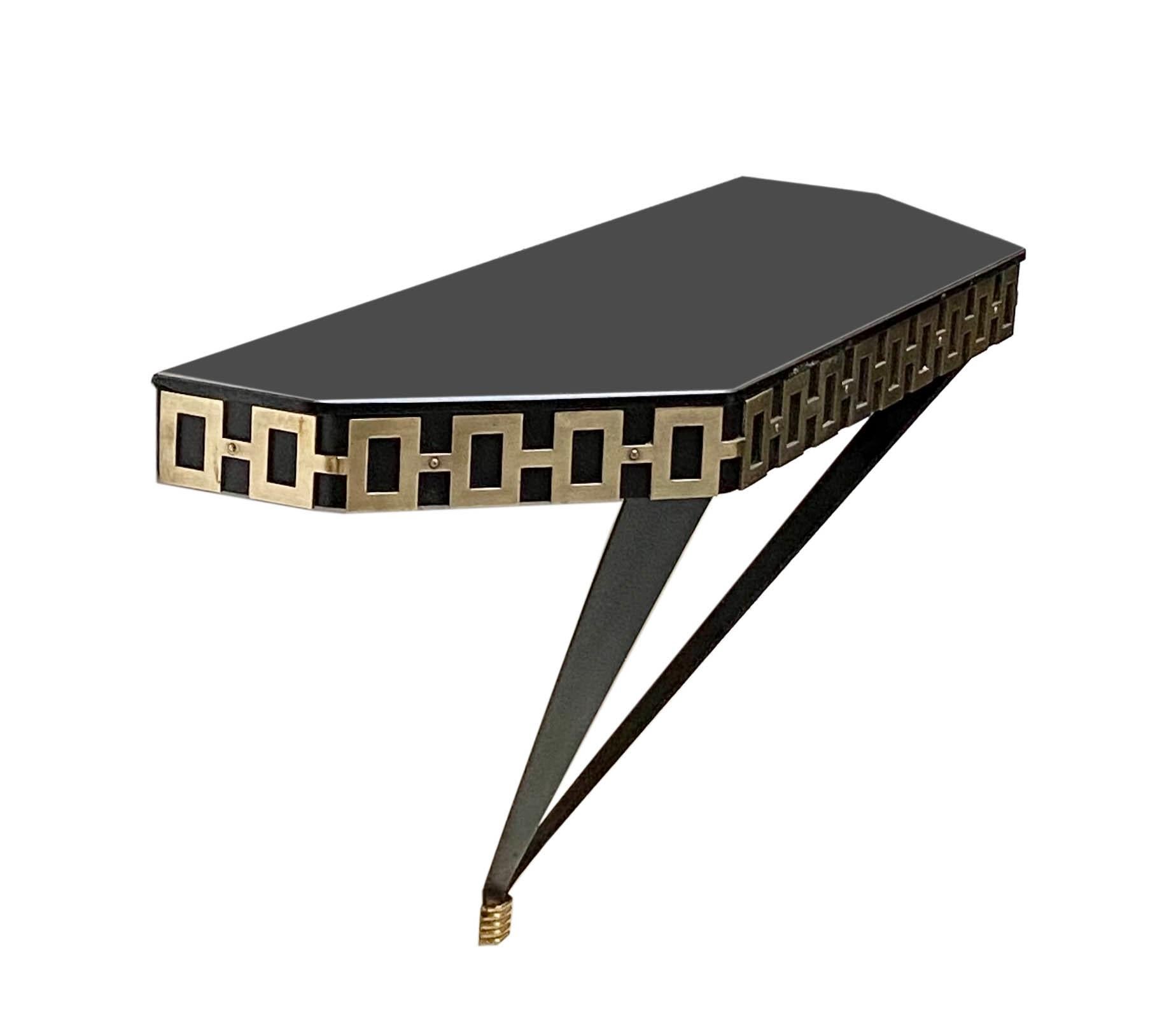 Console with black lacquered metal frame and brass decoration, black polished glass top in the mood of Maison Jensen, 70s.