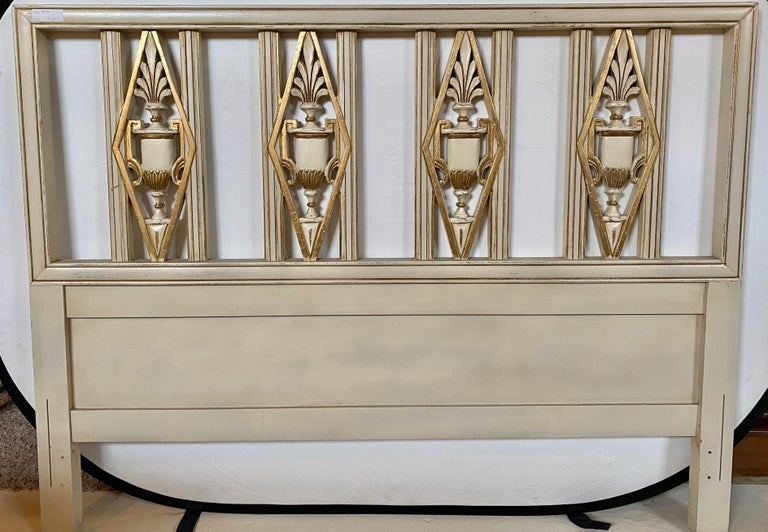 Hollywood Regency headboard. Queen size bed having gilt and paint decorated design with urn form carvings. This finely carved and painted Queen size or full sized headboard will easily fit on any metal frame it is attached to. The whole done in a