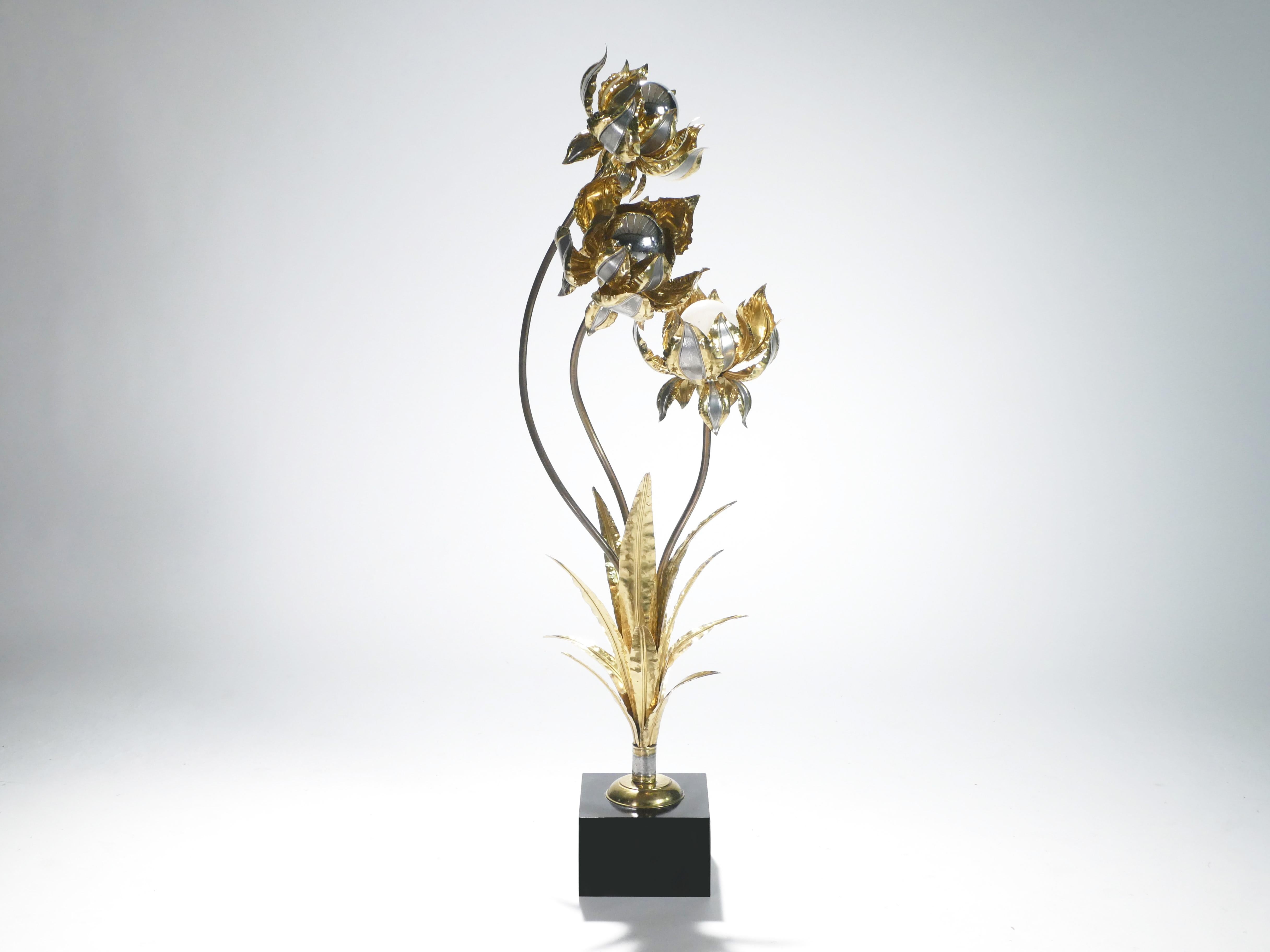 This Henri Fernandez for Maison Honoré floor lamp is exquisitely crafted out of shiny brass and mirrored nickel. Brass leaves fan out from the black lacquer base, and strong, curved brass flower stems stretch upward, culminating in beautifully