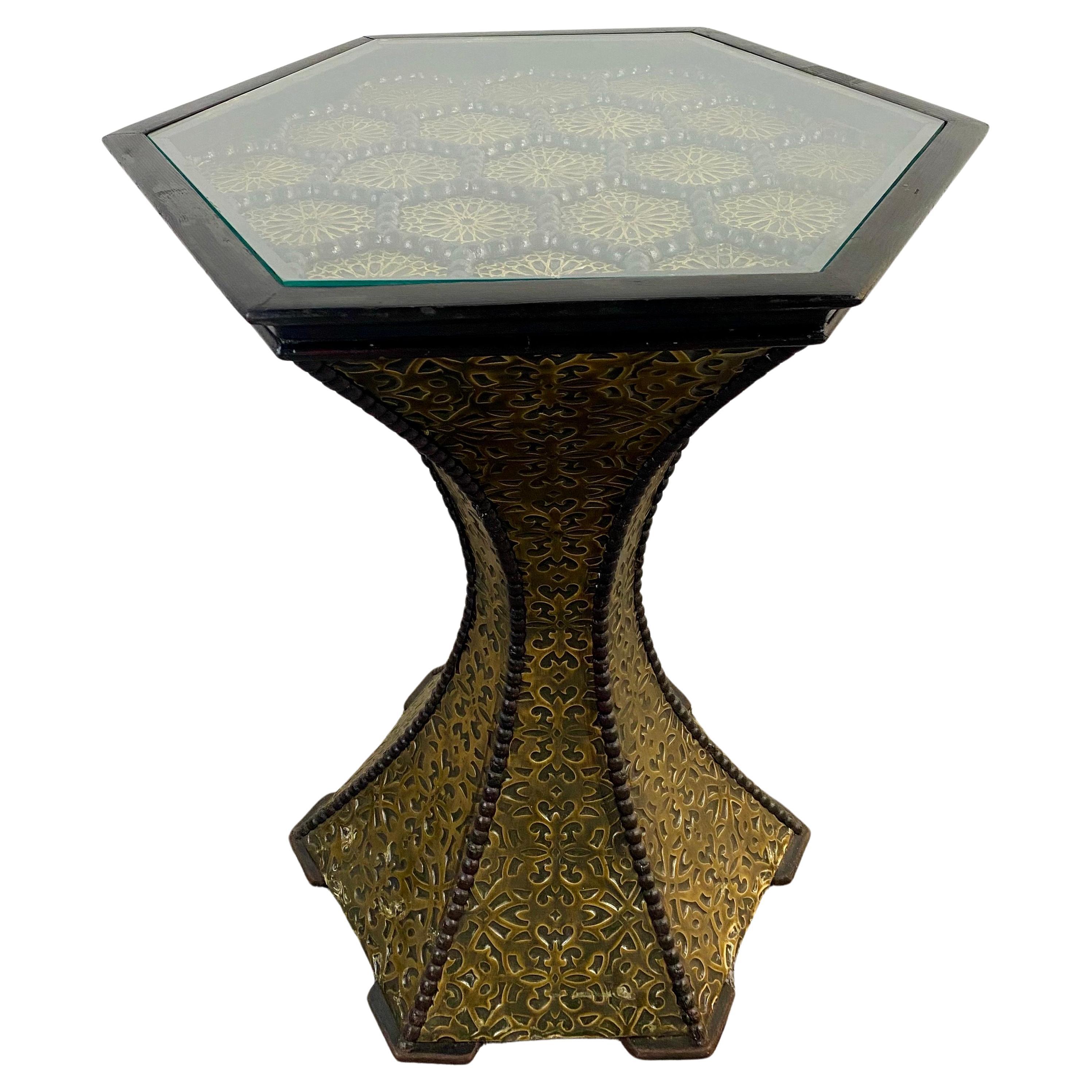 A majestic pair of Hollywood Regency style end or side tables in black ornate with exceptionally crafted antique brass. The pedestal shaped end tables are handcrafted of beechwood and high quality brass. This pair will make a lasting impression in