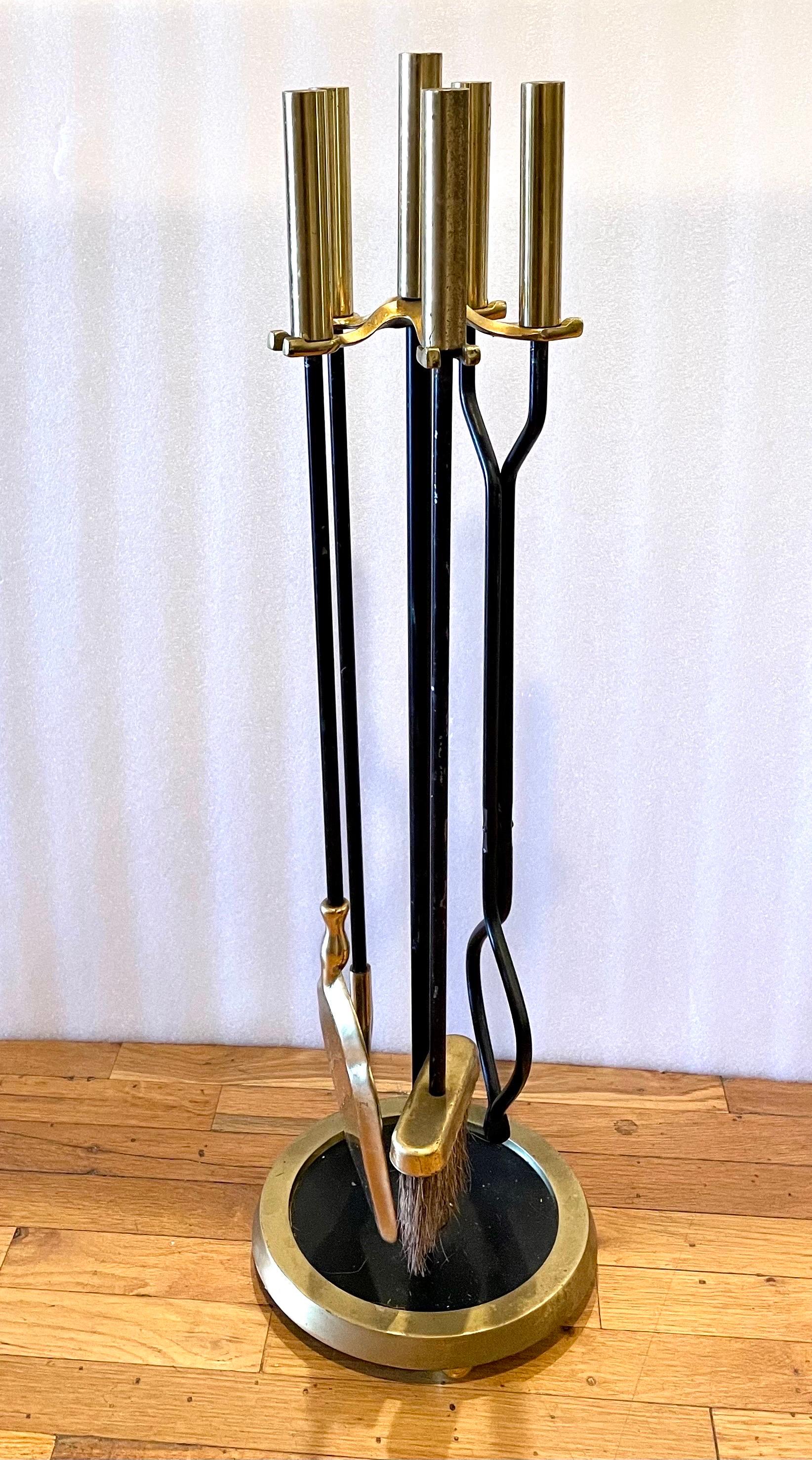 Elegant brass and iron fireplace tool set with beautiful patinated brushed brass handles, circa 1970s. Amazing quality; very heavy with nice detail on the handles. Set includes a shovel, brush, poker and log holder.