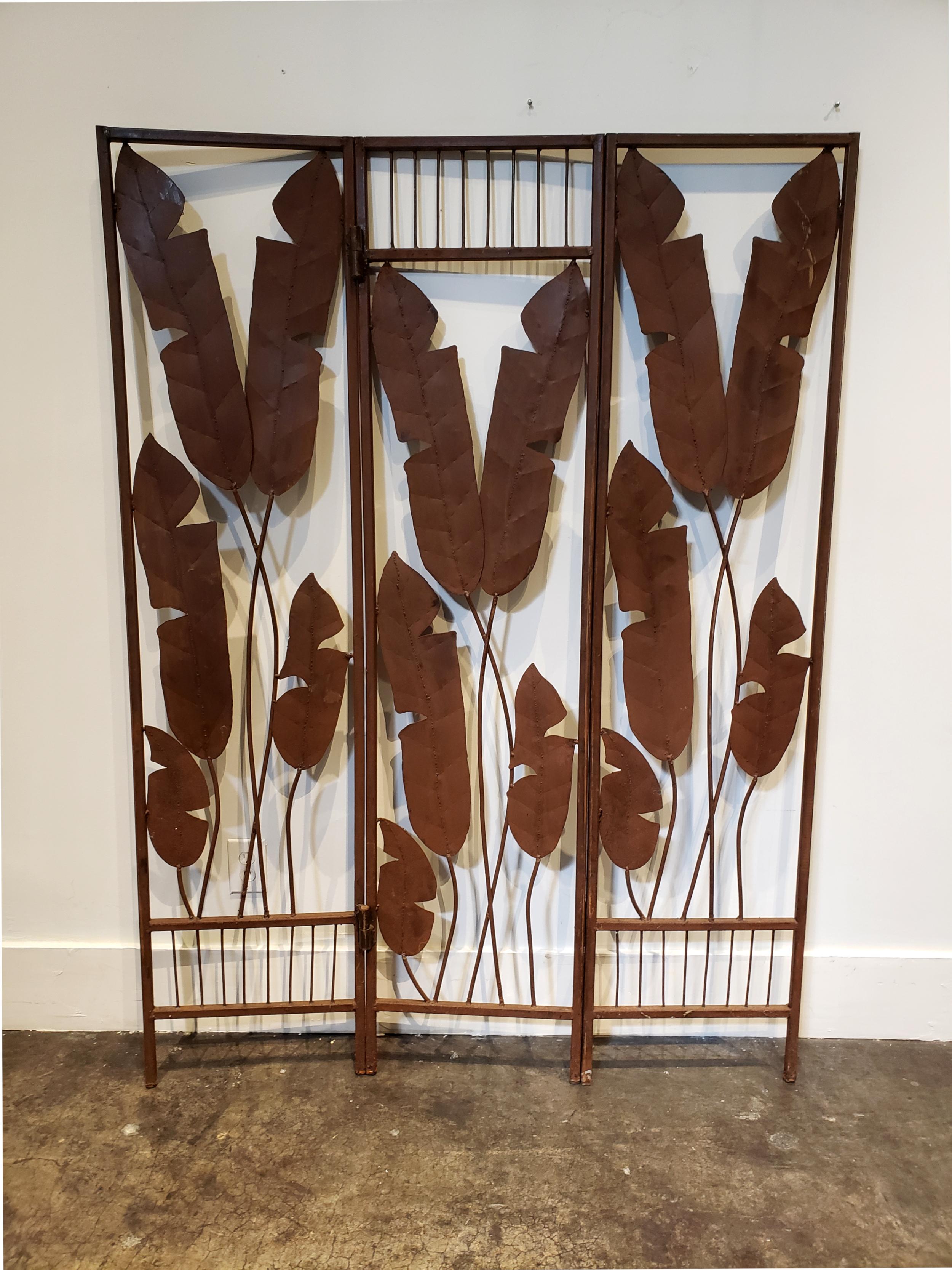 Midcentury Hollywood Regency iron folding screen with banana leaf motif in three panels. Soft brown patina from age/rust.

Dimensions when fully extended (leaned against a wall): 52.5