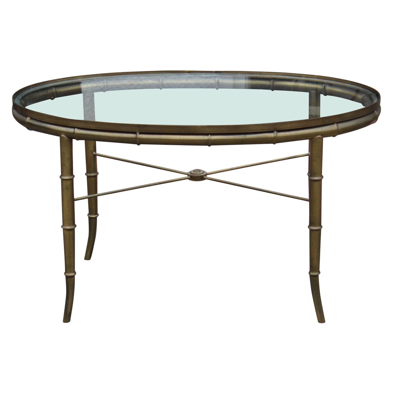 Hollywood Regency / French style Italian brass and glass oval coffee table with faux bamboo brass legs.
