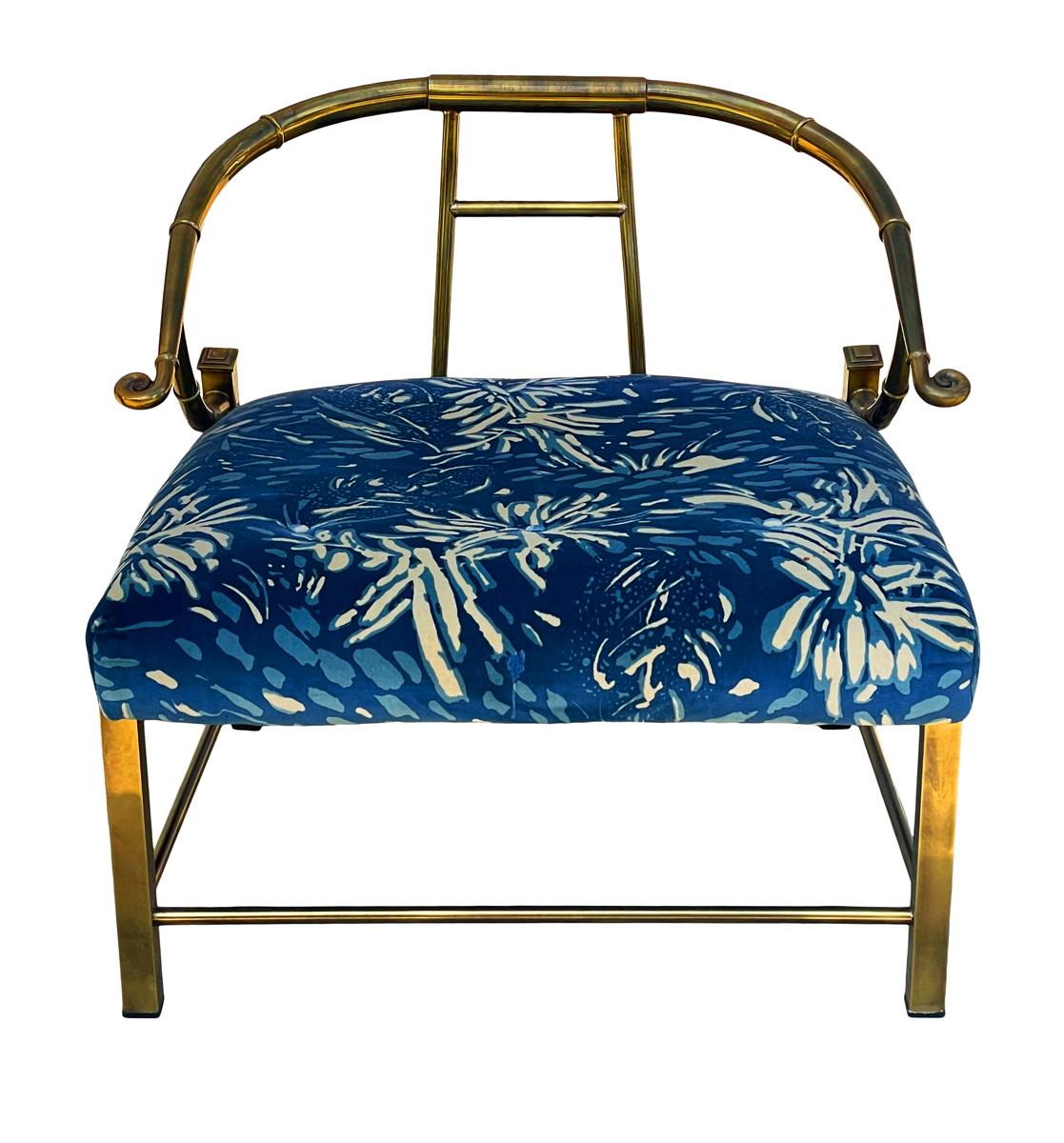 A Classic well built asian inspired lounge chair produced by Mastercraft in the early 1970s. It features a heavy brass framing with the original decorator fabric. Ready for use.