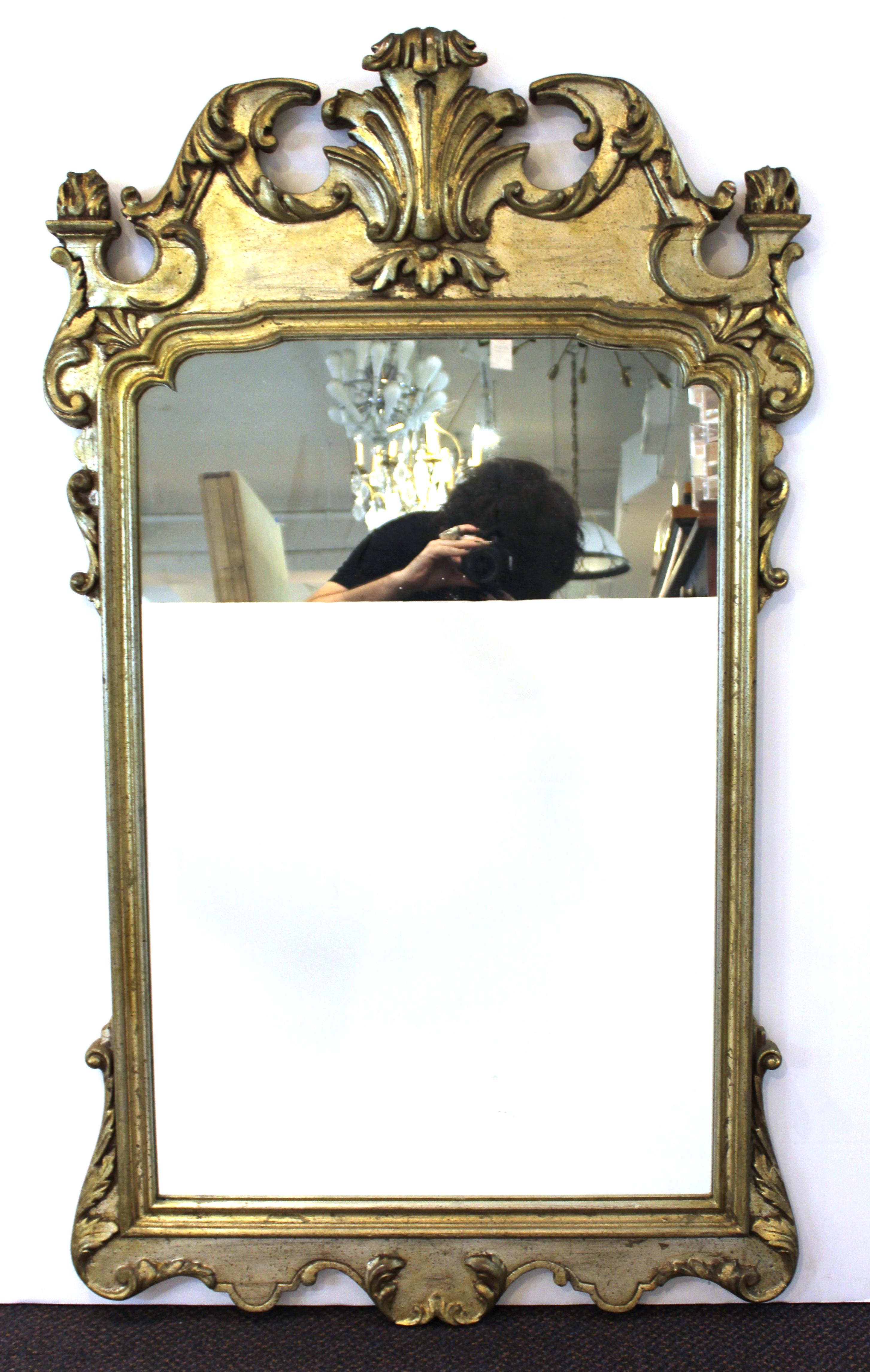 Italian Hollywood Regency pair of wall mirrors in Chippendale style in silvered wood. Label on the back 