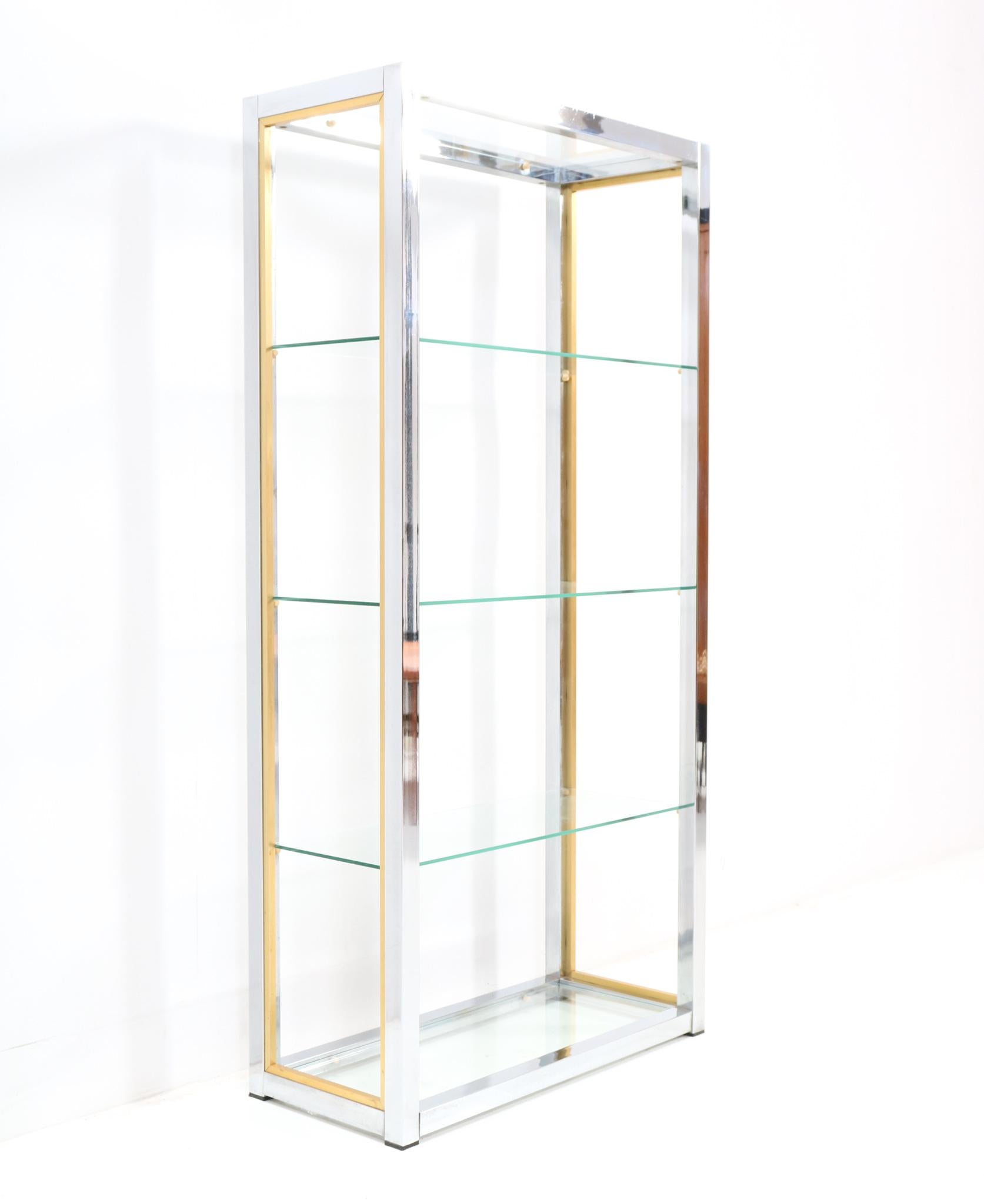 Stunning Hollywood Regency etagere or display piece.
Design by Renato Zevi.
Striking Italian design from the 1970s.
Original chrome and brass frame with five glass shelves.
This wonderful Italian etagere or display piece by Renato Zevi