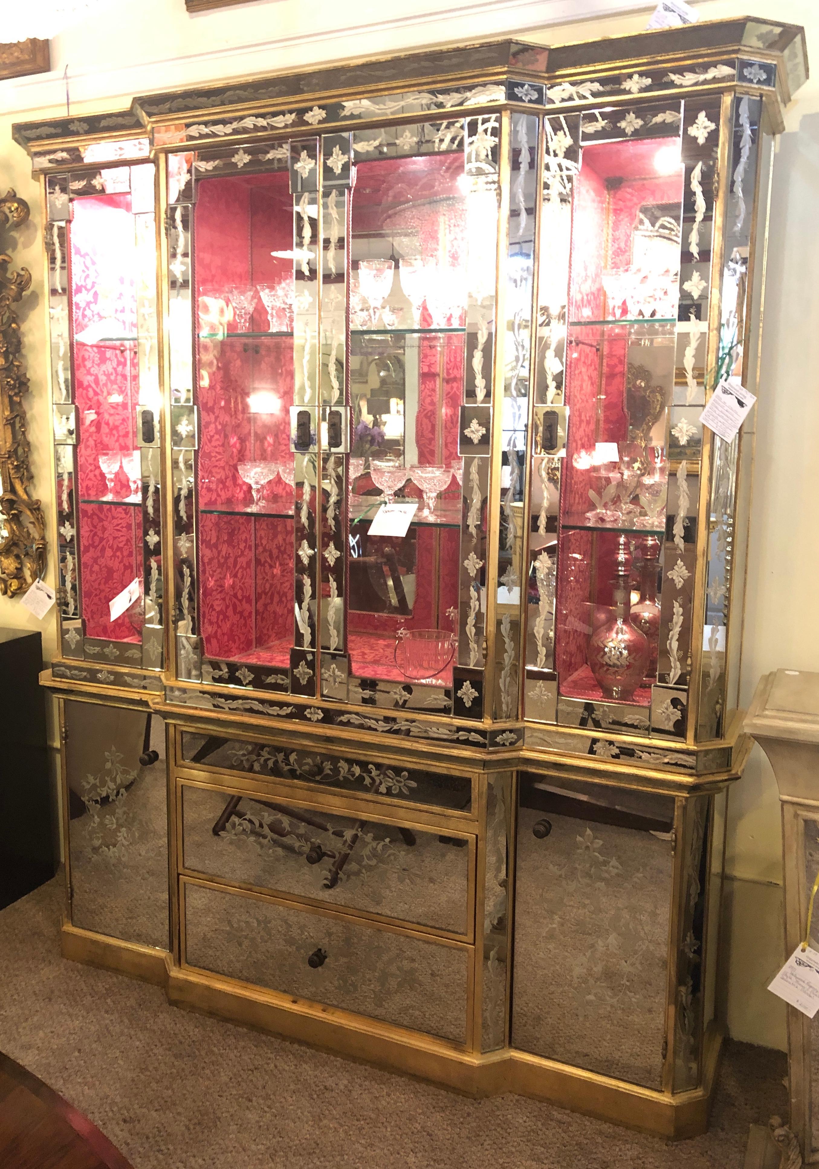An Italian églomisé glass and mirrored panel breakfront / sideboard or China cabinet. This spectacular Hollywood Regency etched glass and églomisé cabinet simply defines sleek and stylish. The mirrored all around sideboard having three drawers, the
