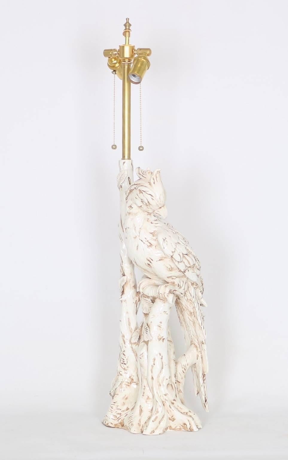 Italian Hollywood Regency majolica parrot-form lamp in white. There are two available (price is per item). Each lamp is fully restored with all new wiring and hardware including a double socket cluster. 

The noted height is to the finial and the