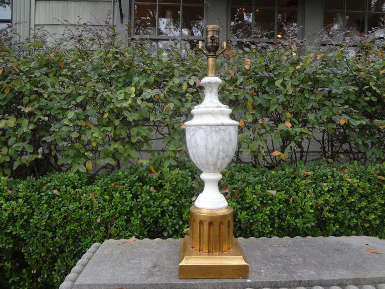 Stunning Hollywood Regency Italian marble lamp with giltwood base. This lovely vintage Italian marble urn form lamp has been newly wired to U.S. specifications with a new socket and ready for the shade of your choice.