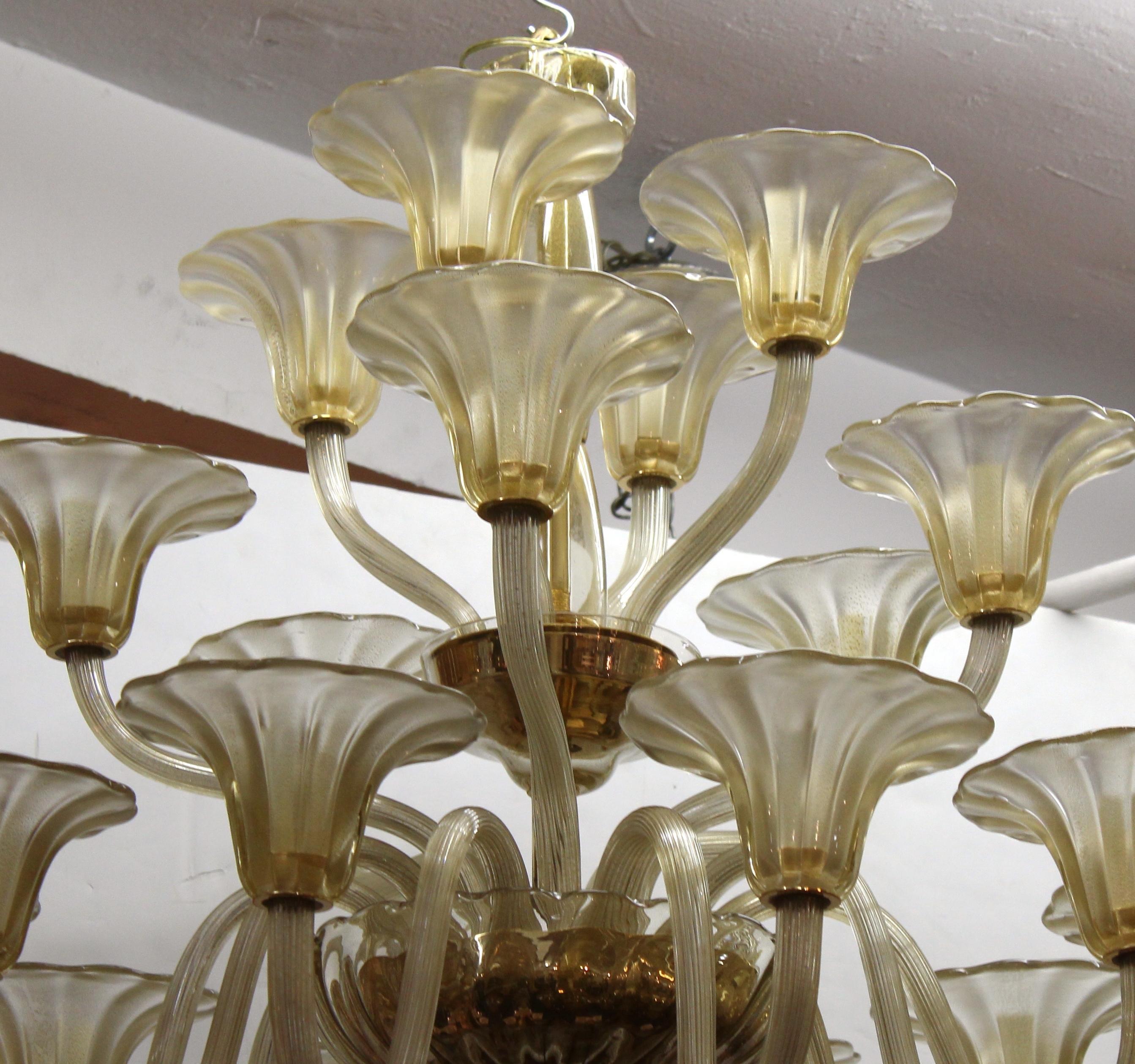 Hollywood Regency Italian Murano glass three-tiered chandelier with elaborate glass designs reminiscent of vegetation and flowers. The item was made in Italy in the mid-20th century and is in great vintage condition.
