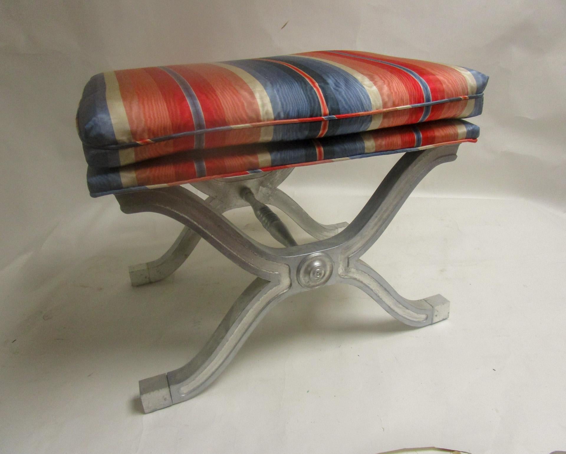 This stunning pair of solid mahogany with silver gilt curule stools are of Hollywood Regency design and handsomely upholstered in a colorful striped moire. Dorothy Draper Henredon Heritage.