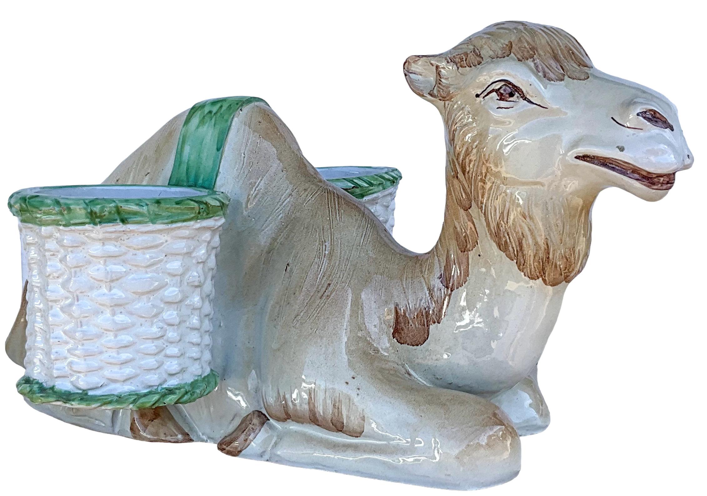 This is a Hollywood Regency Era Italian terracotta camel form planter / cachepot. It has dual baskets for spring decorating. It could also work as a condiment serving piece.  It is in very good condition..