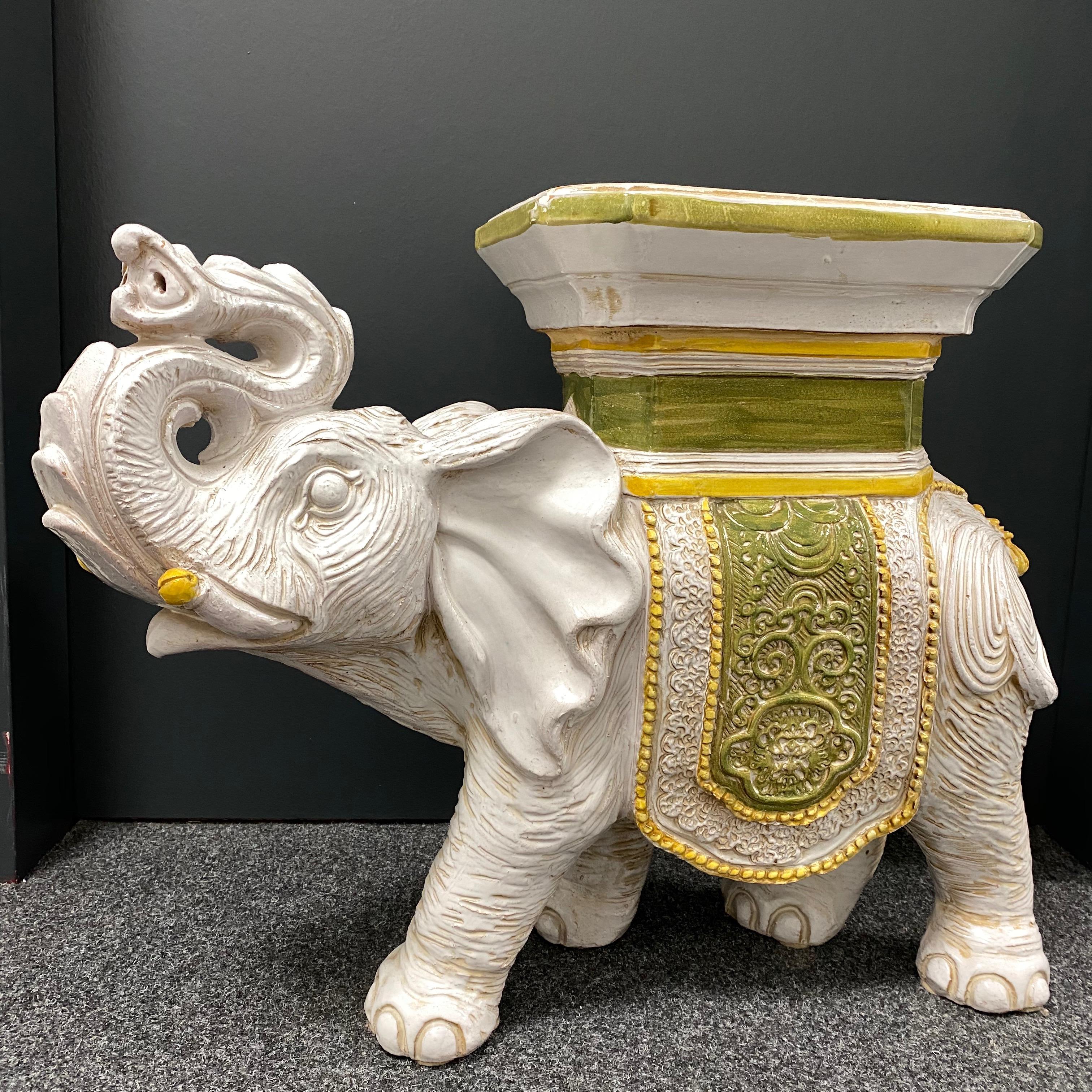 Mid-20th century glazed terracotta garden stool plant stand or seat, flower pot seat or side table. Handmade of terracotta. Vintage garden seat in the shape of an elephant with a pedestal top, all in cream white ceramic with yellow and green