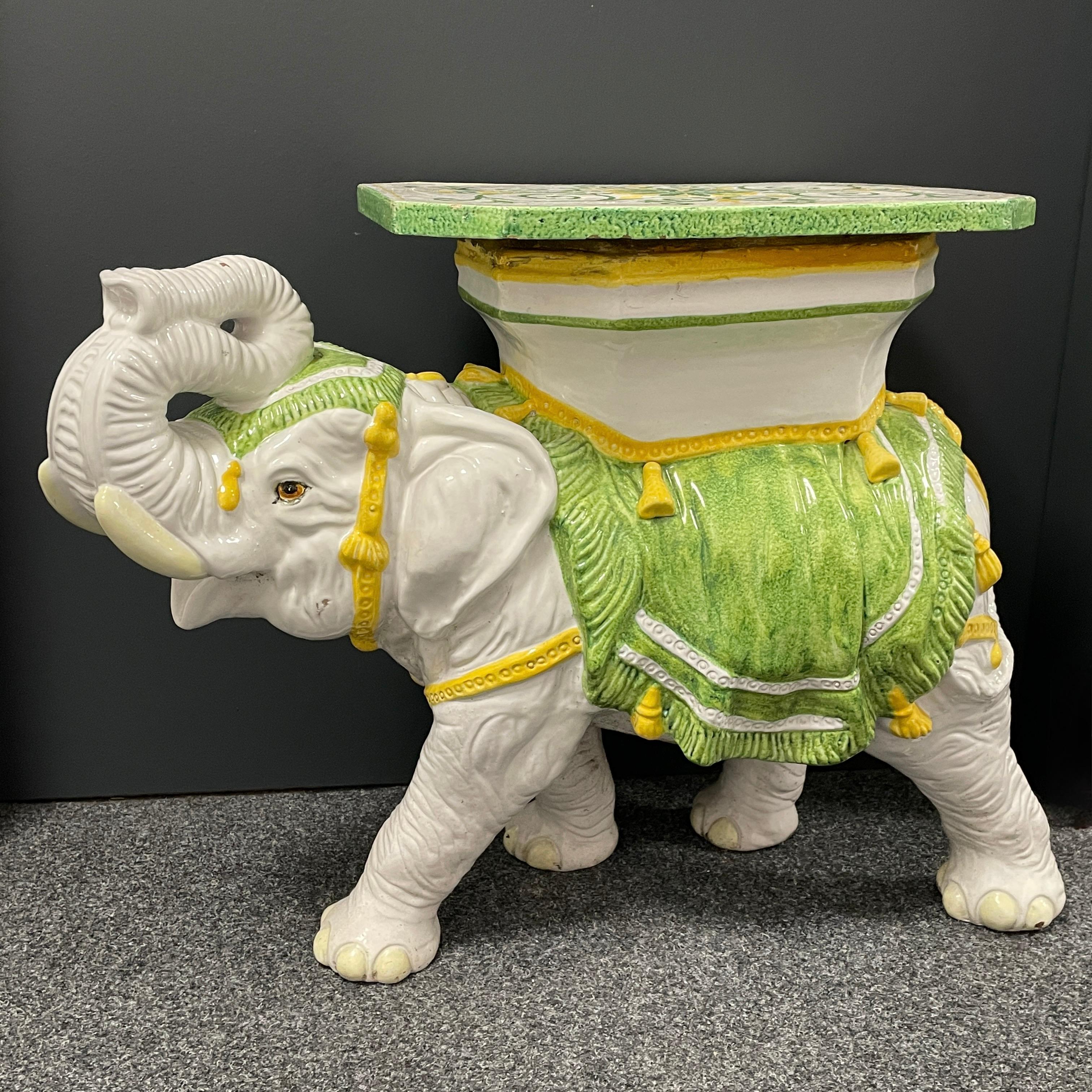 Mid-20th century glazed terracotta garden stool plant stand or seat, flower pot seat or side table. Handmade of terracotta. Vintage garden seat in the shape of an elephant with a pedestal top, all in cream white ceramic with yellow and green