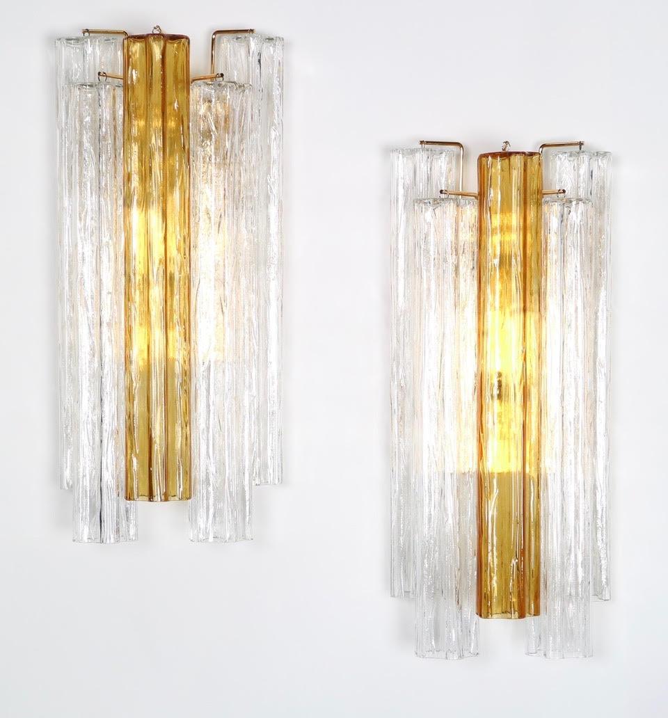 Hollywood Regency large Venini wall sconce made with five tronchi glass pieces: Four clear pieces and one amber piece. Made in the 1950's in Italy, with the largest tronchi glass Venini made (20 inch / 50 cm long). Each sconce uses 2 regular bulbs