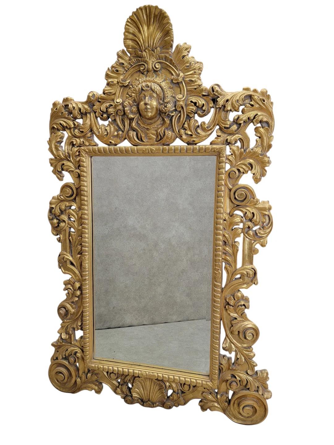 Vintage Hollywood Regency Italian Versace Style Carved Ornate Gold Gilded Figural Beveled Wall Mirror 

This exquisite vintage Hollywood Regency wall mirror embodies the opulence of Italian design, featuring intricate carvings and ornate detailing