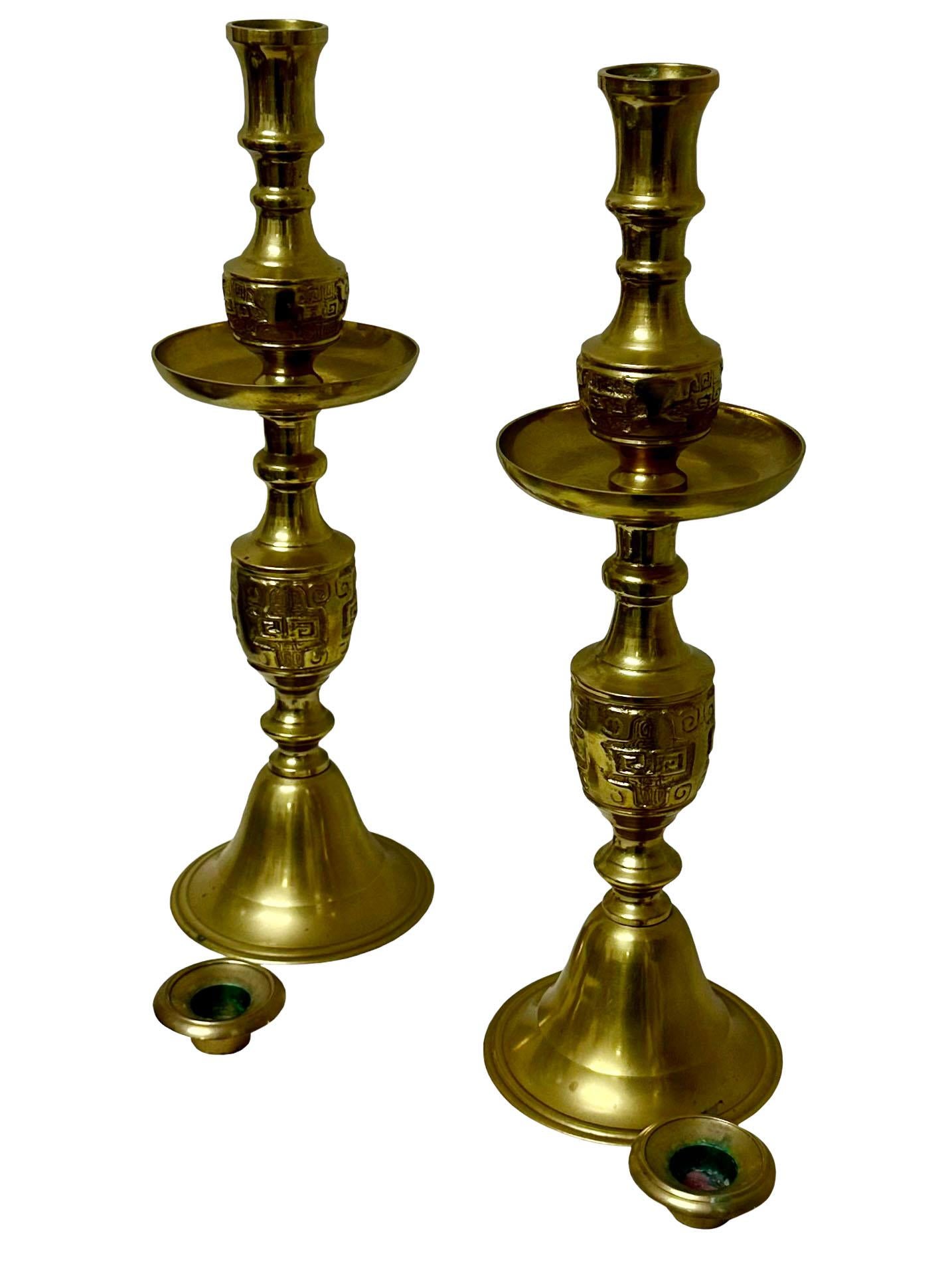 A striking pair of 1950's Hollywood Regency candlesticks are by James Mont in the asian taste. There's a bow sash on each one.