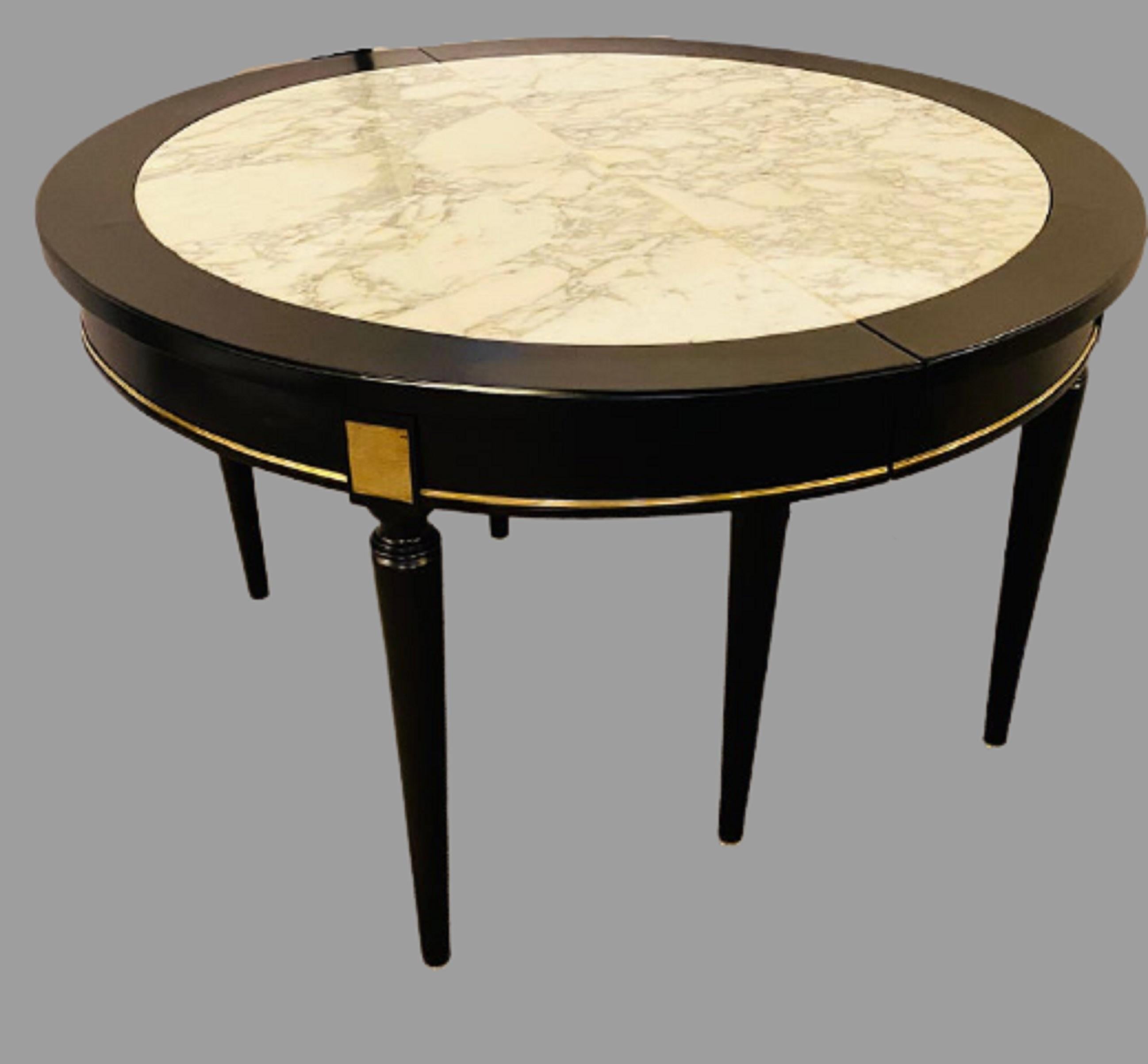 French Hollywood Regency Jansen style ebony center or dining table. Part of our extensive collection of over forty dining tables and chair sets as seen on this site, thus why we are referred to as the King of Dining rooms.
Having a Carrara white