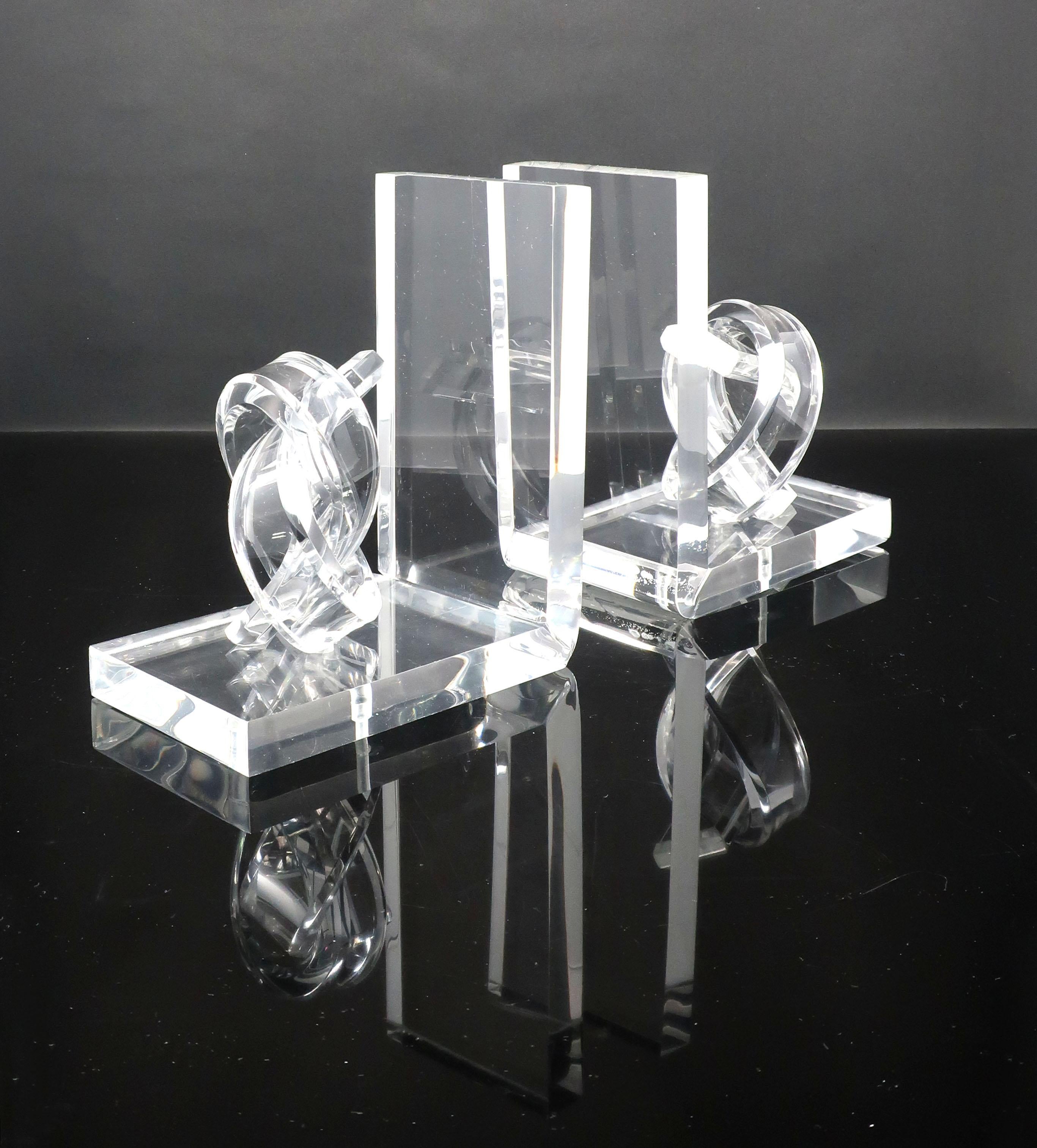 A gorgeous set of mid-century modern Lucite bookends with twisted Lucite knots. The light-catching clear acrylic adds a polished element to any bookshelf.

Measures: 3.5