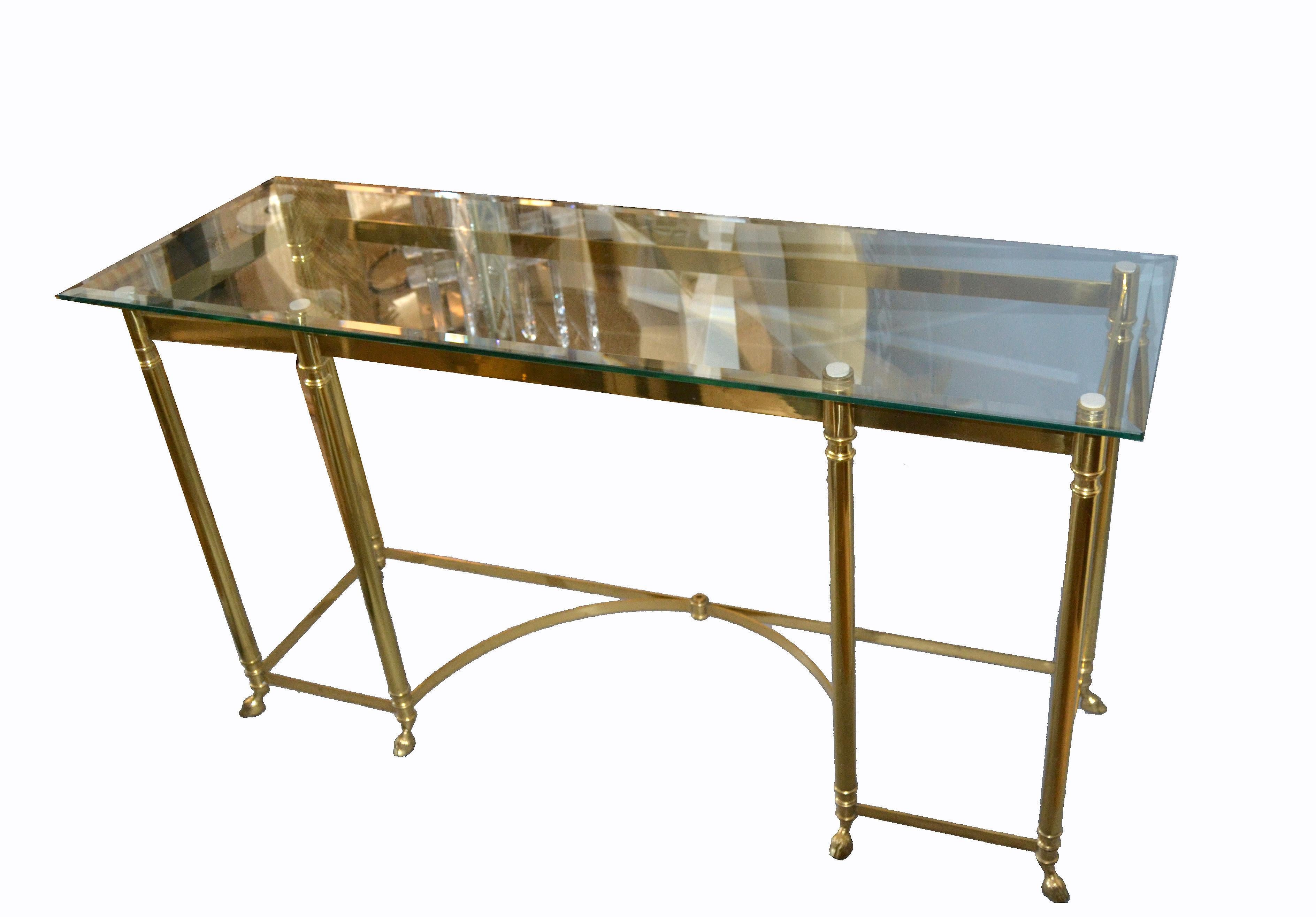 A Hollywood Regency Classic long labarge brass and beveled glass top console or sofa table with brass hoof feet.
All American design with great craftsmanship and attention to the details.
  