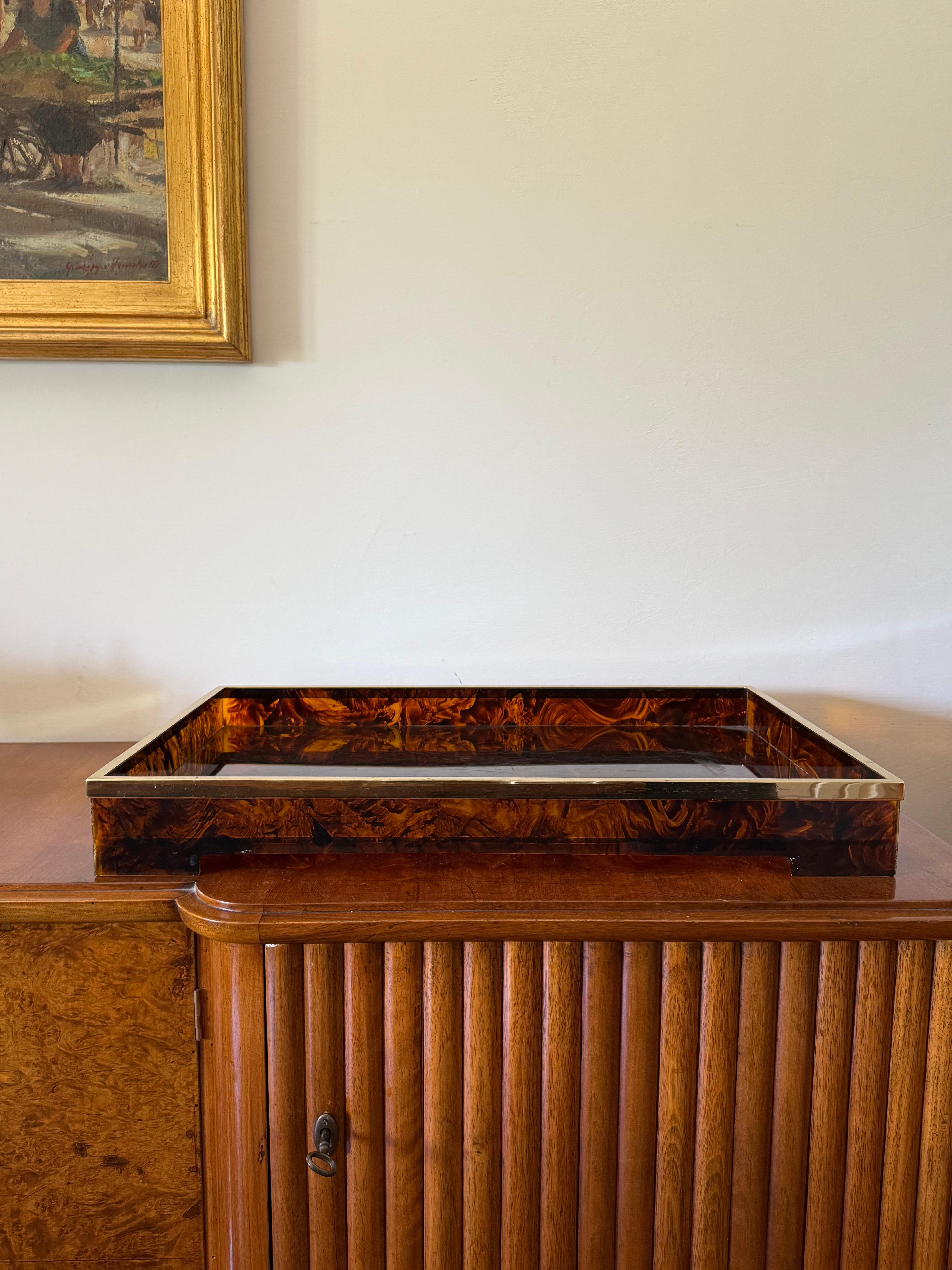 Brass and tortoiseshell lucite tray 

Italy 1970s

brass, lucite

H 7.5 cm x 61 × 41 cm

Conditions: good consistent with age and use, Defect, crack on one leg, check the last photo