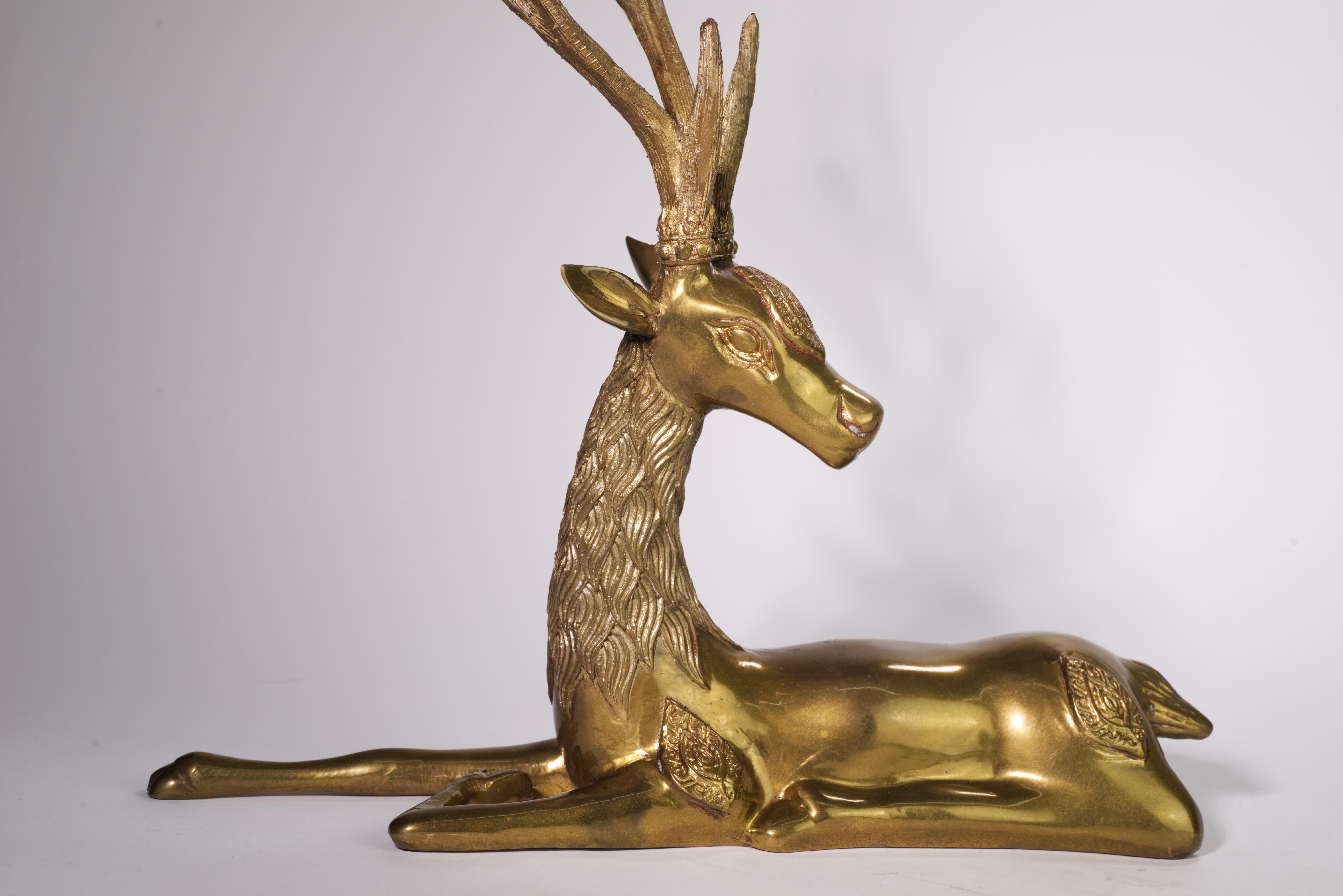  Vintage large reclining deer sculpture has abstract ornaments on the deer's forehead and on its flanks above each leg; the antlers and the body are highly detailed without appearing too ornamental.

The sculpture lost its manufacturer sticker, but