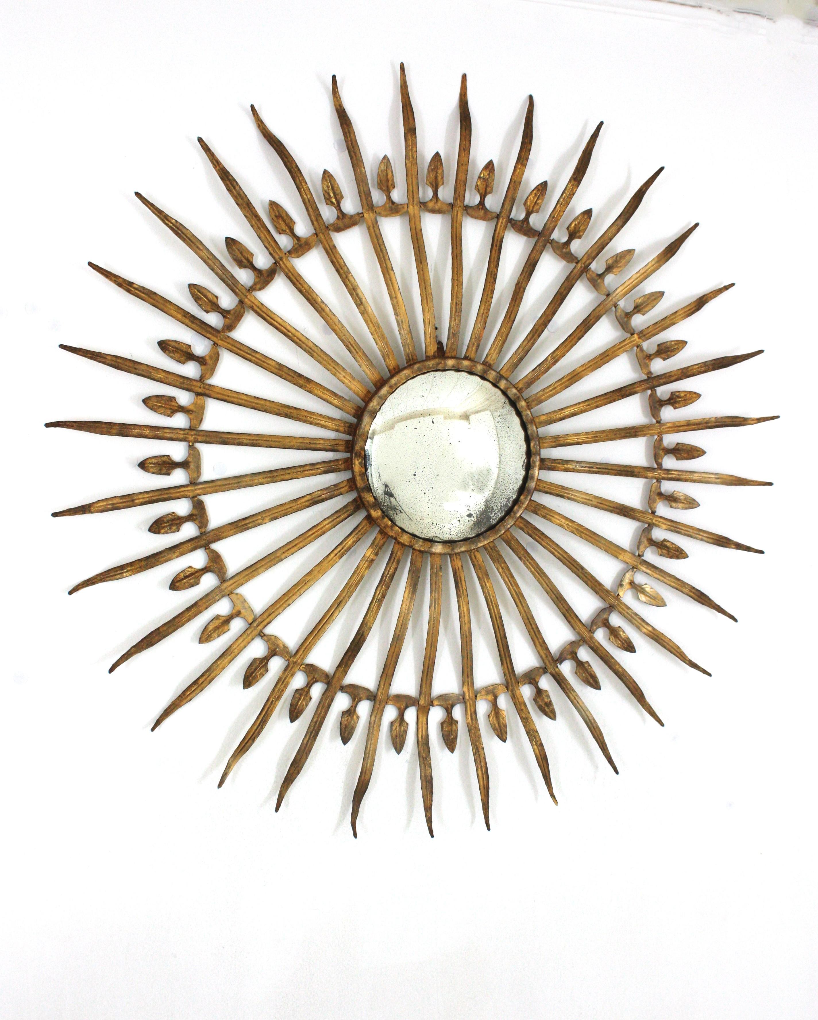 Large Scale Oversized Sunburst Mirror, Iron, Gold Leaf
Outstanding Hollywood Regency gilt wrought iron convex sunburst /starburst mirror, Spain 1950s
Extra large size (39,37 inches) and convex glass mirror. It has a terrific aged patina with gold