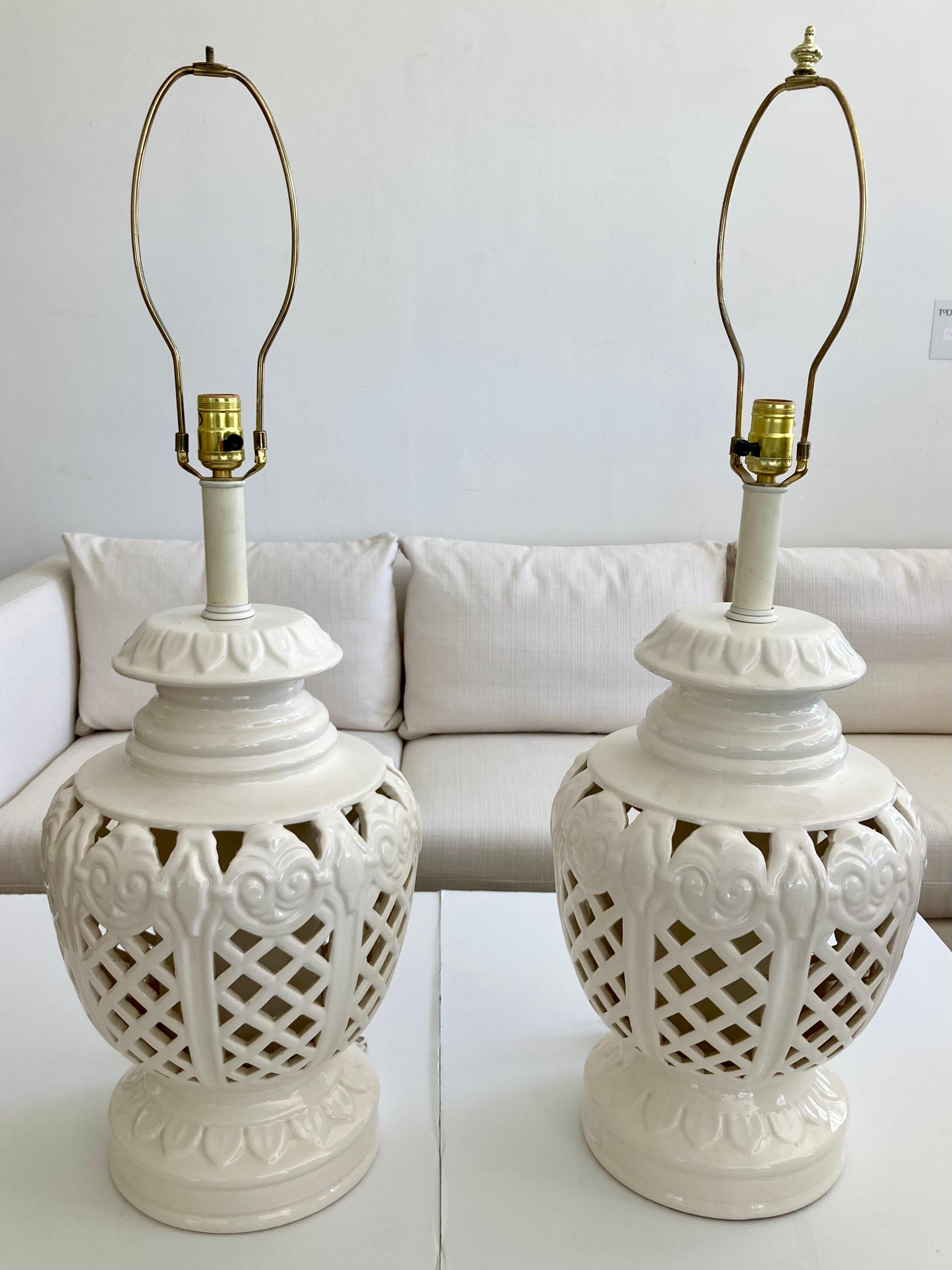 Fabulous pair of all original Hollywood Regency white glazed ceramic table lamps. Just add your favorite style of shades for your design project. Big scale lamps so plan the correct table selection especially with your shade choice. Old school