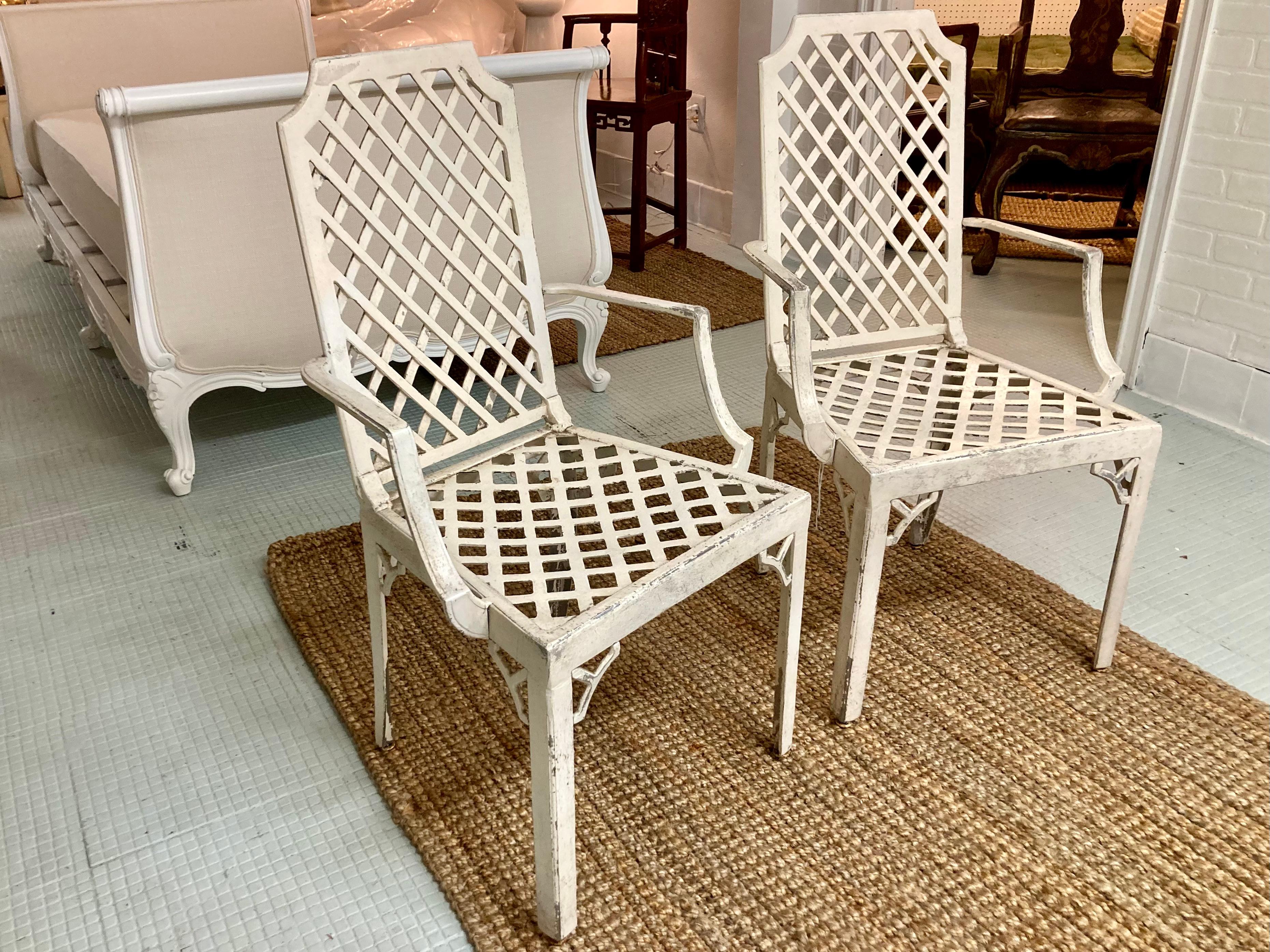 Beautiful pair of Hollywood Regency lattice pattern patio arm chairs in original finish. Amazing details with lattice pattern and also Chippendale details under seat. Add some Hollywood Glam to your home.