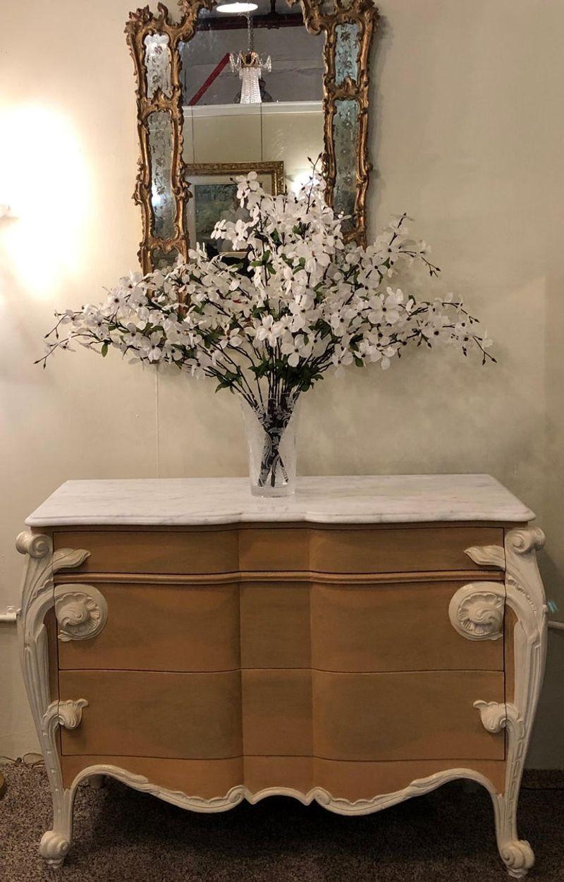 Hollywood Regency Louis XV Commode, nightstand or dresser by Casaragi
 
Casaragi marble top commode or dresser in French Louis XV style. The wonderful 3 drawer serpentine front is embellished with richly carved Art Nouveau scrolls and foliate