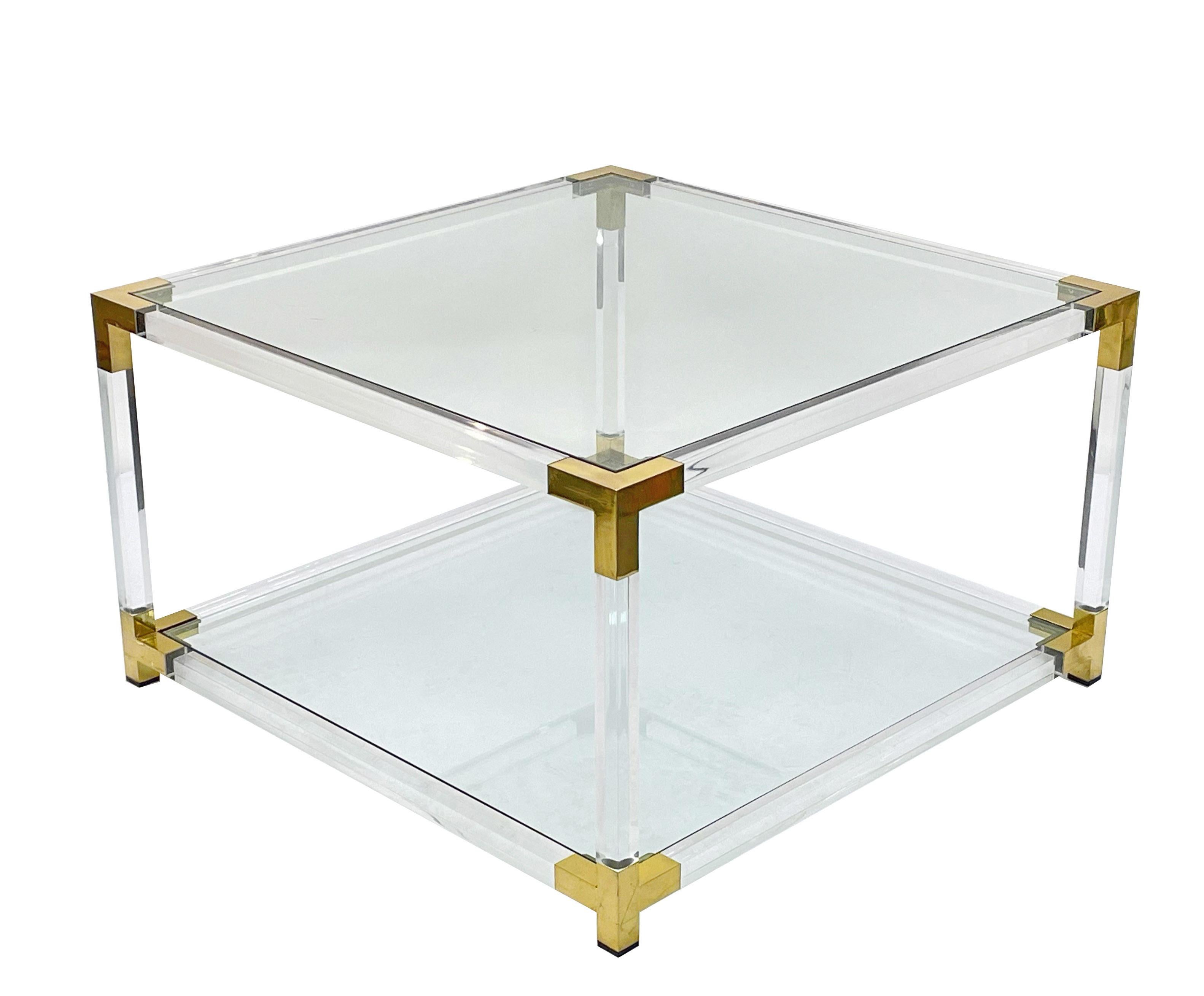Wonderful mid-century Hollywood Regency coffee or cocktail table with two glass shelves. This amazing table is in the style of Charles Hollis Jones and was produced in Italy during the 1970s.

This piece is fabulous because of its Hollywood