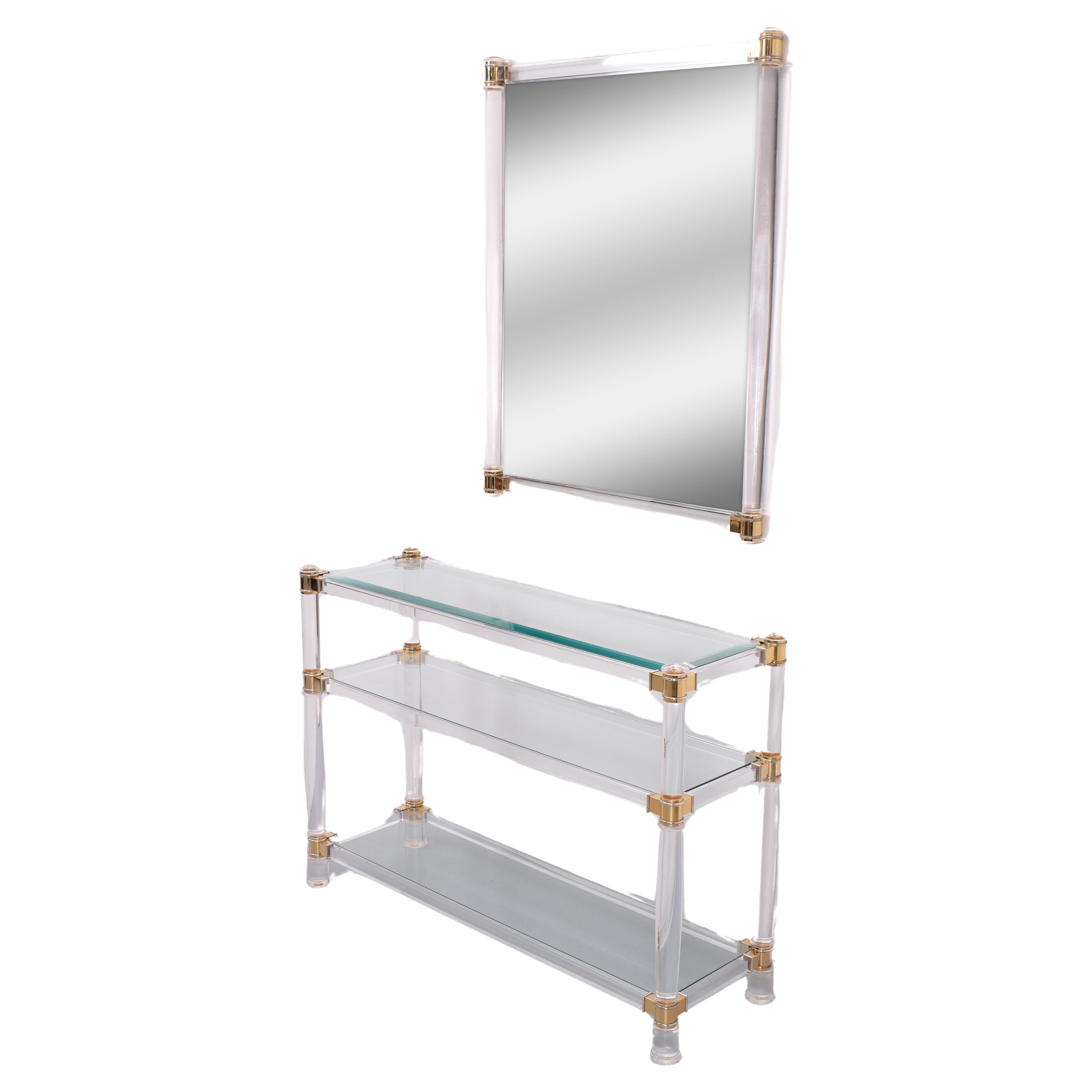For sale Beautiful set of Three tier console table and the original matching Mirror 
The table comes with 3 Glass plates .The top One is beveled .Clear Lucite ,
comes with Brass connections .The beveled Mirror comes with solid Lucite columns  .
Very