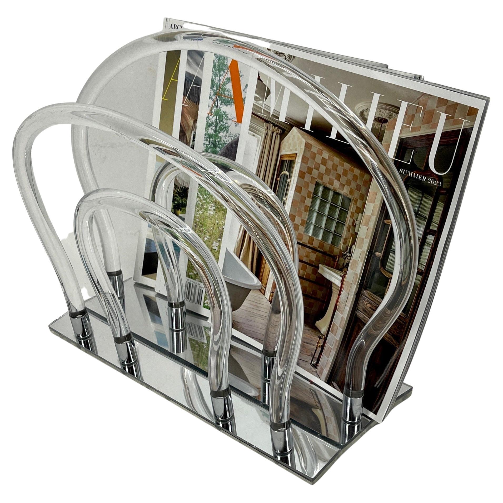 Vintage Dorothy Thorpe Waterfall Magazine Rack in Lucite, Mirror-glass and Chrome Hardware

This eye-catching Hollywood Regency bent lucite, chrome and mirror glass magazine rack or stand. This eye-catching piece is created from 6 bent lucite rods