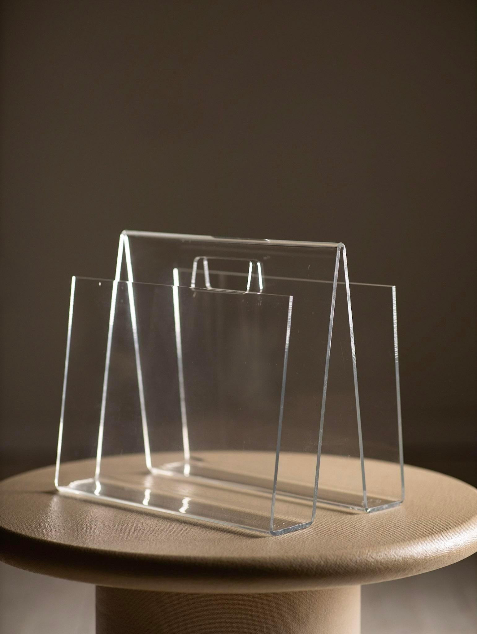 Hollywood regency lucite magazine holder. One single sheet of lucite is used to sculpt a 