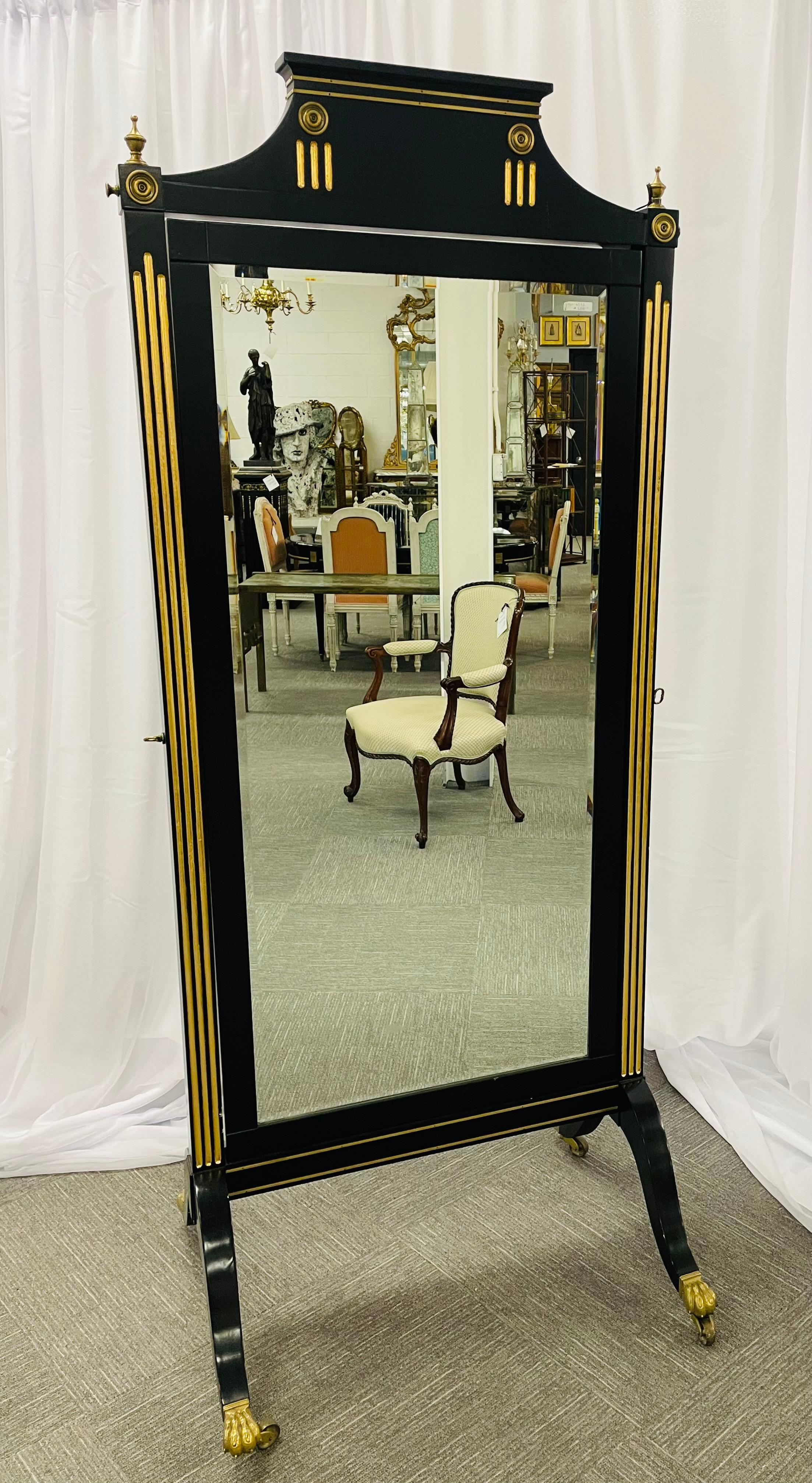 A one of a kind ebonized Maison Jansen cheval mirror. A great Russian neoclassical styled design with bronze claw feet and casters supporting a gilt gold and bronze-mounted wood frame support to hold a center framed beveled mirror. The overall piece