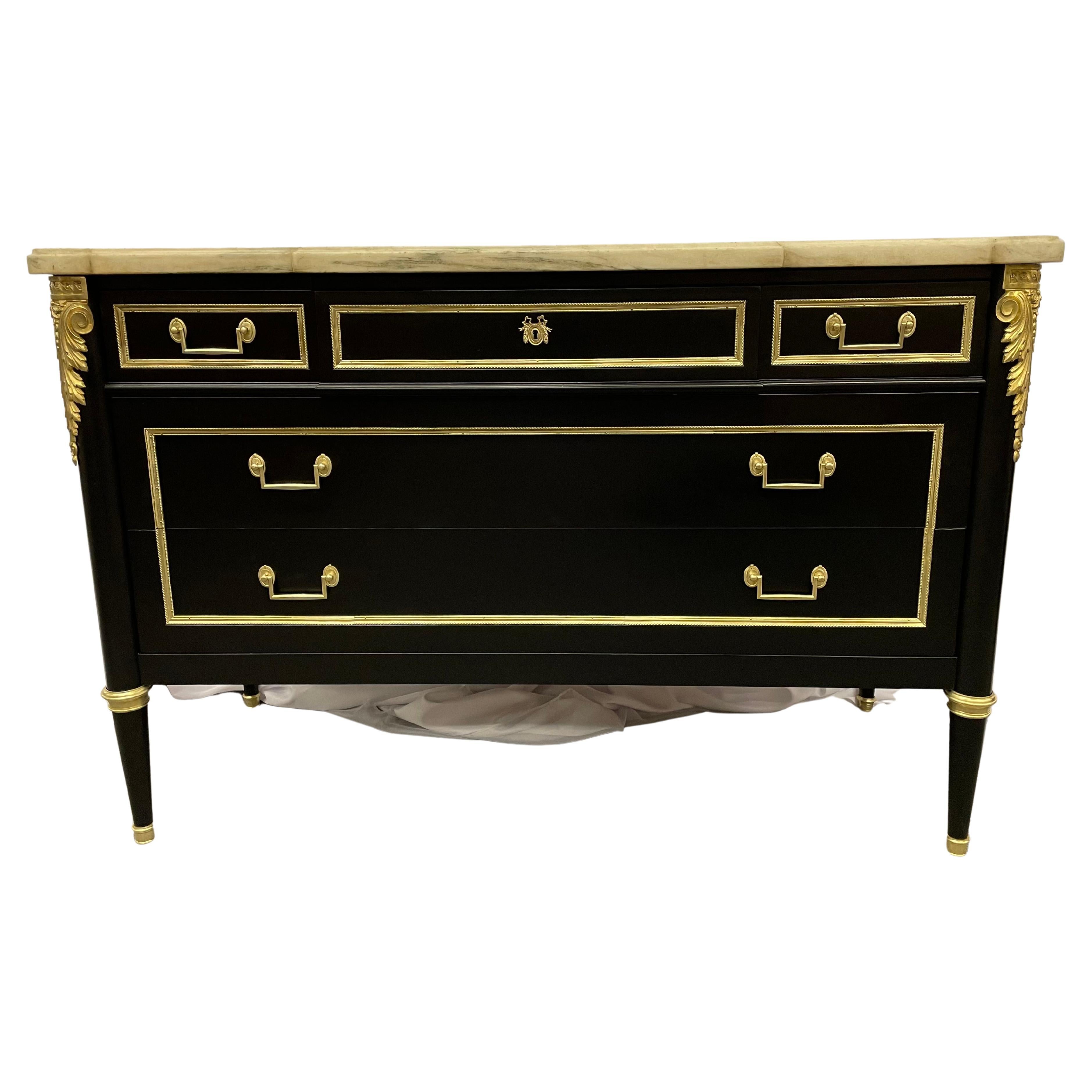 Maison Jansen Ebony bronze mounted commode, chest, dresser having bronze mounts with bronze framed drawers and side panels supporting a White Carrera Marble Top. The stunning commode has three over two bronze framed drawers with bronze drawer pulls
