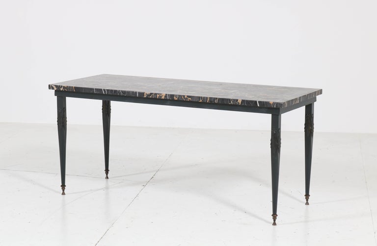 Magnificent Hollywood Maison Jansen style coffee table.
Striking French design from the 1970s.
Green lacquered metal base on solid brass feet.
With original and hard to find Pyrénéese Portor marble top.
In very good condition with minor wear