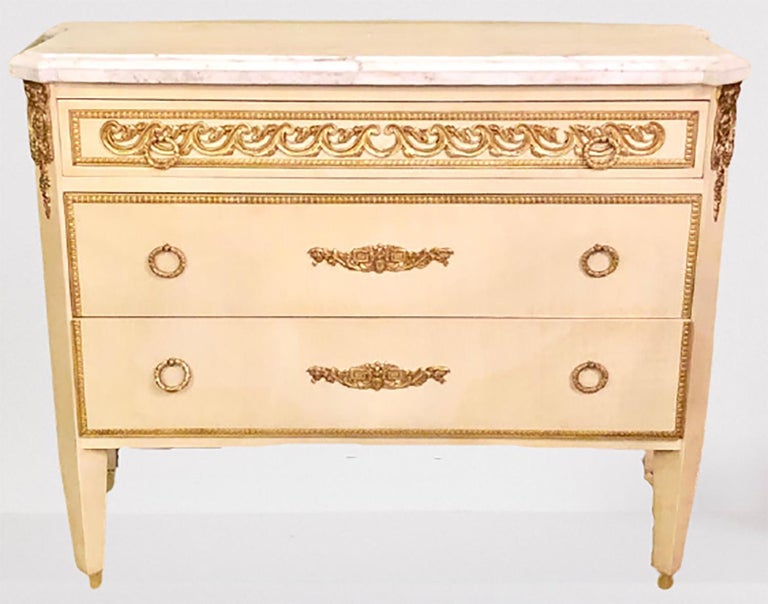 Hollywood Regency Maison Jansen style commodes / cabinets / nightstands a pair. This offer for a fine pair of three graduating Maison Jansen style, in a faux linen white hand painted finish having a marble-top with bronze mounts commodes, cabinets,