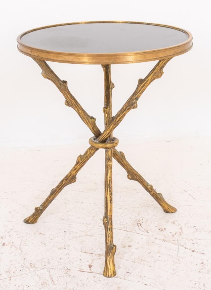 Hollywood Regency Manner gilt metal Twig table, with round black granite top above a tripod support of three twigs in naturalistic faux bois. Measures: 21