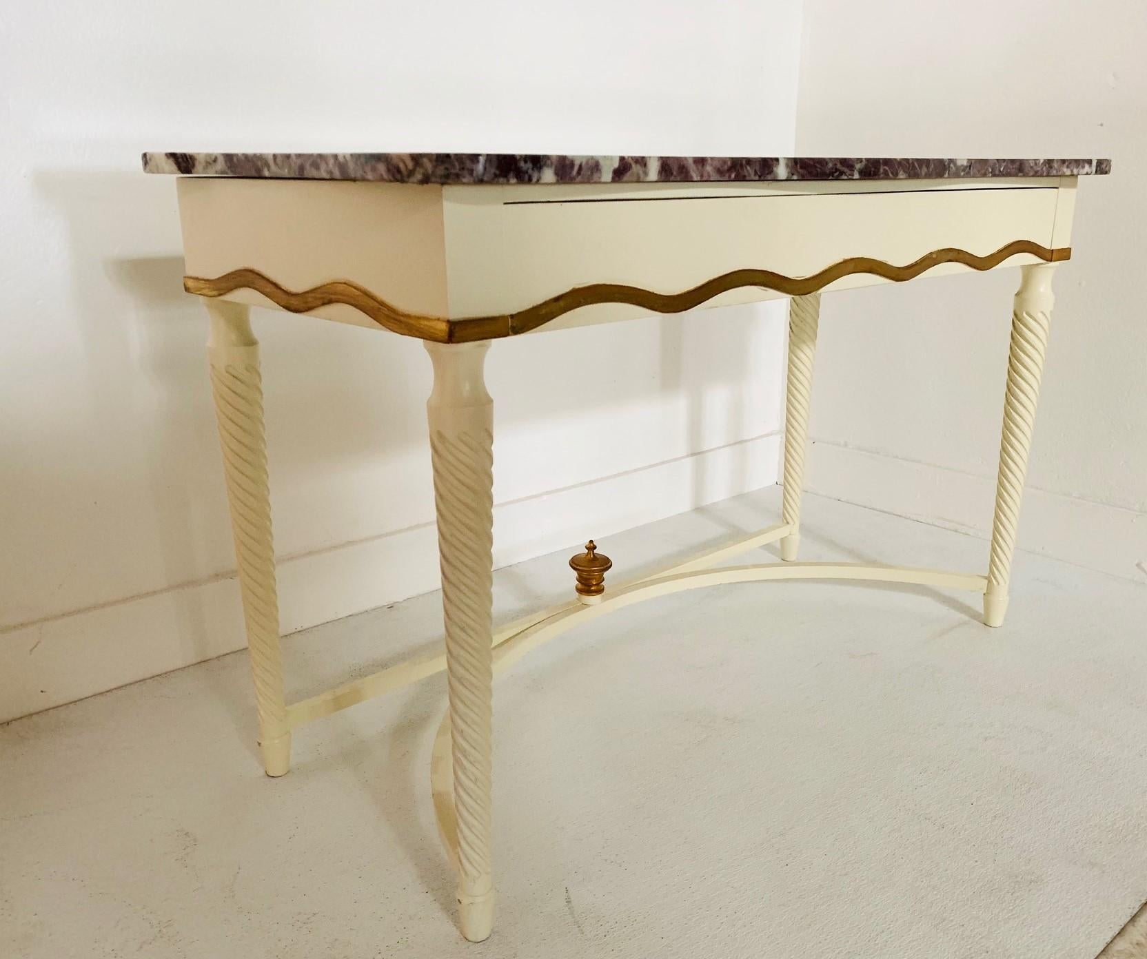 Hollywood Regency marble-top console. Console is wood with a white lacquered finish. Has a pull-out drawer with gold trim and a gold finial.