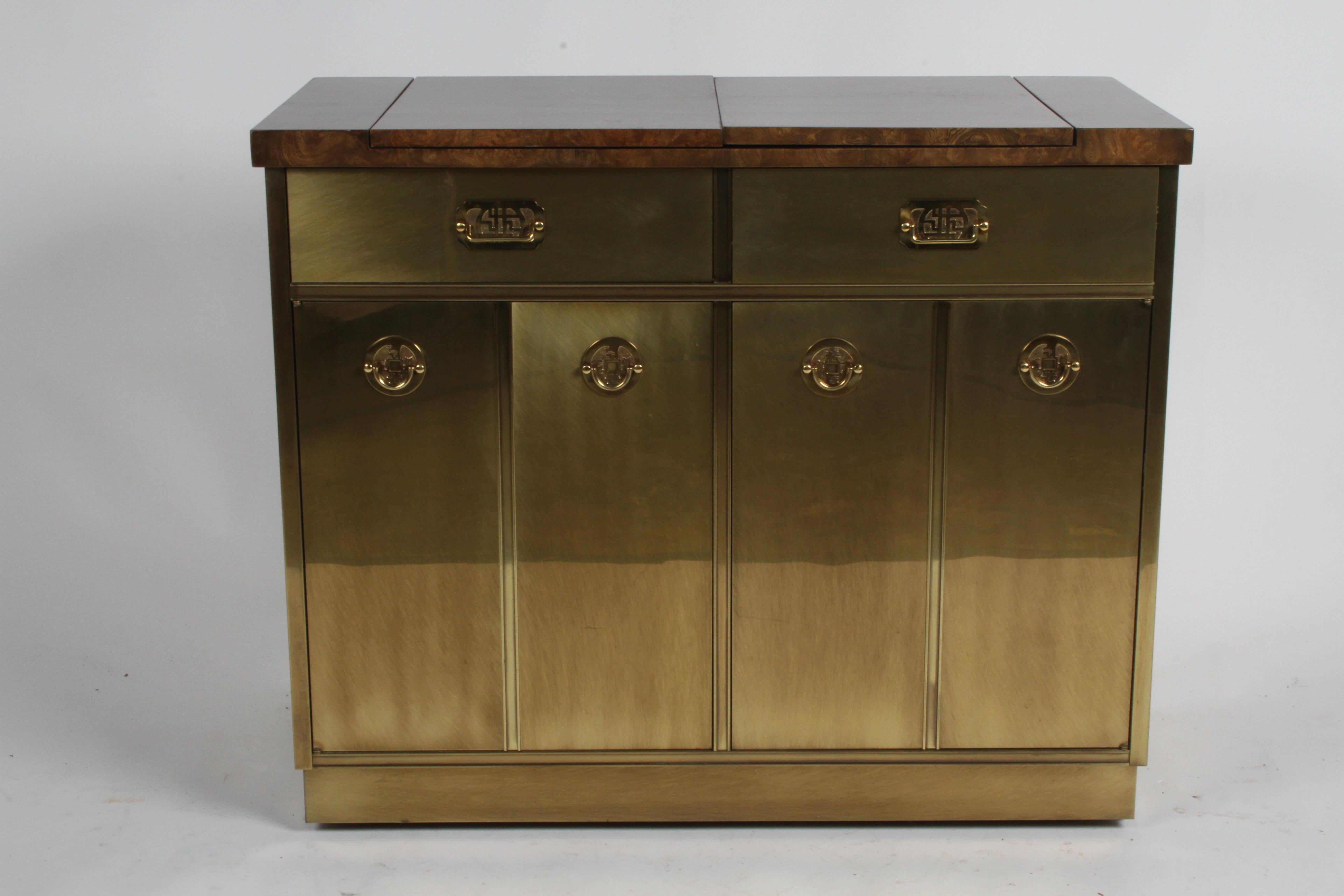 Beautiful 1970s Mastercraft dry bar, cart or server with warm factory applied patina to the brass cladded cabinet and elm burl veneer flip top for extra serving space. Drawers and doors have Asian inspired hardware, lower cabinet has two doors that