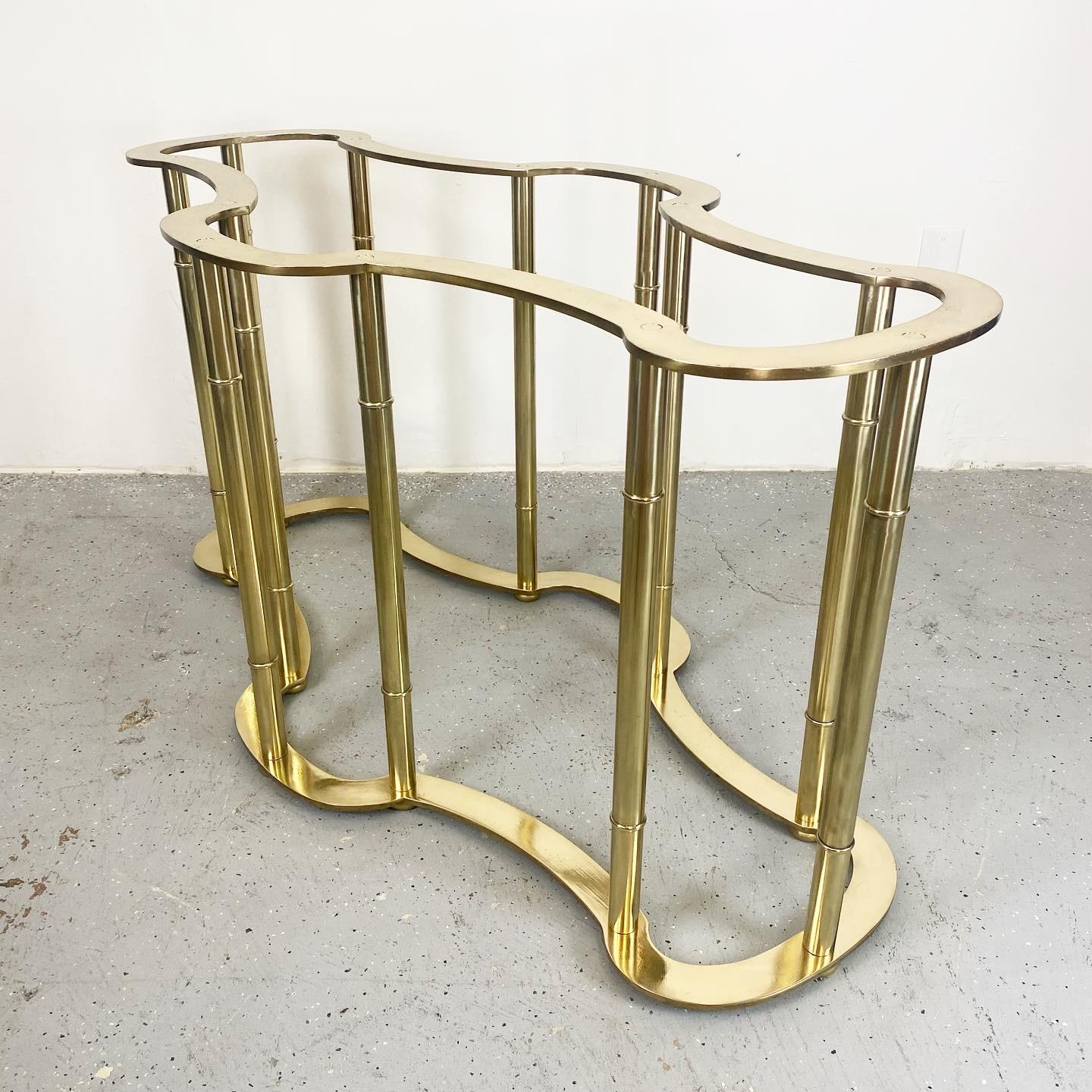 An outstanding polished brass dining table base. This piece is modern and elegant with minor patina throughout.