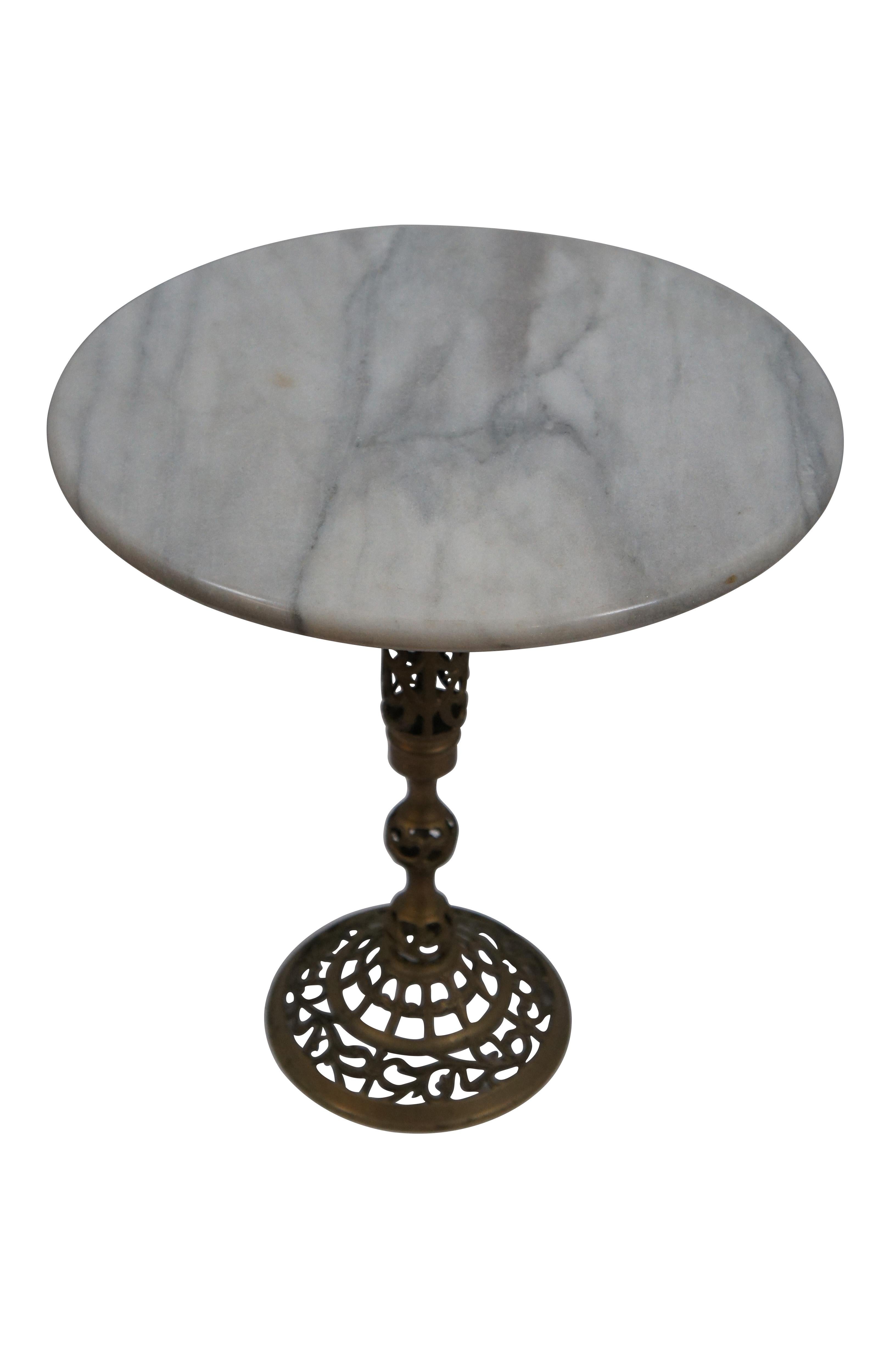 Vintage Hollywood Regency plant stand / end table with a round white and gray veined marble top, perched on an elegant pierced / open brass work base featuring a lattice of foliate leaves. Made in Taiwan R.O.C. Item number 004.


DIMENSIONS

15.25”