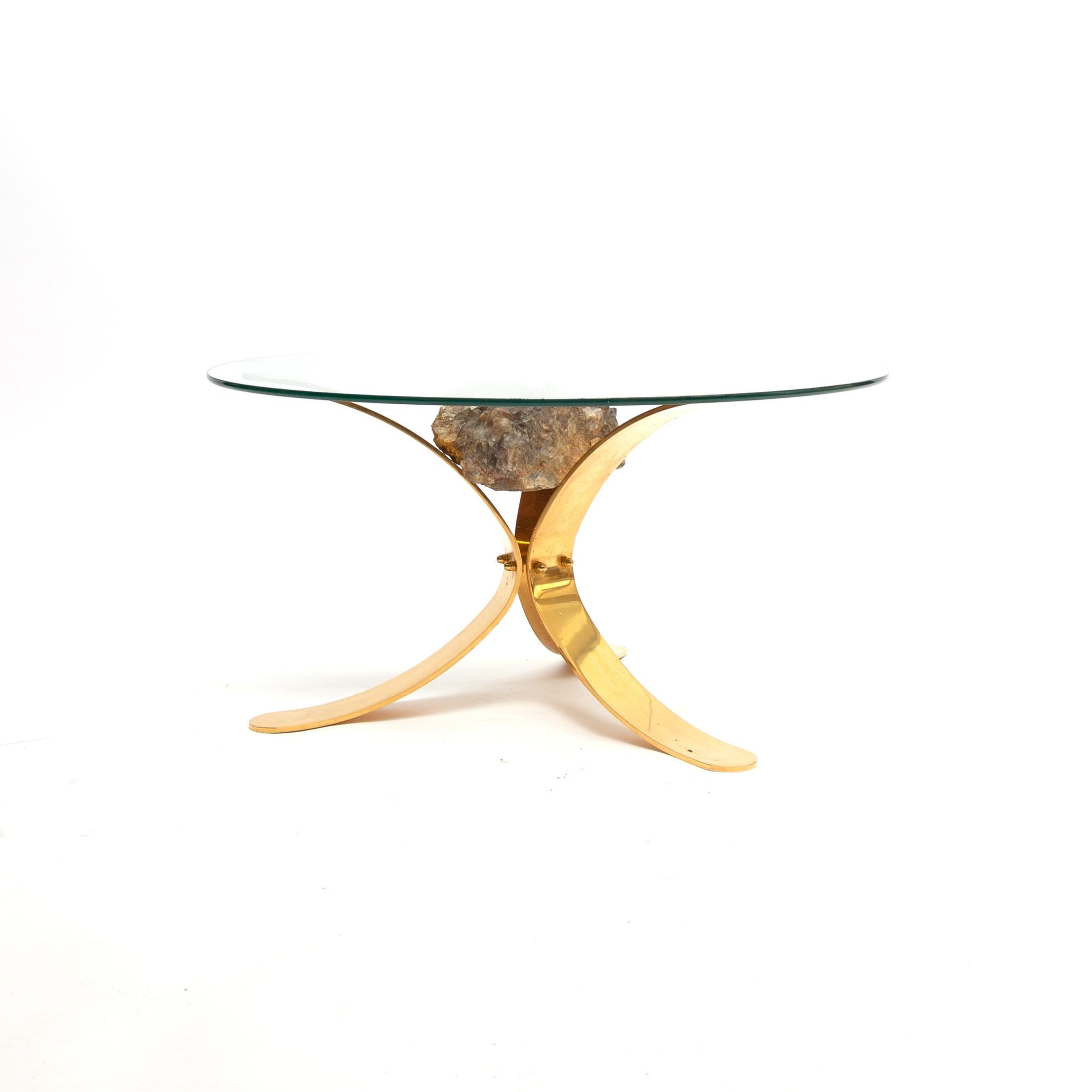 Unique Hollywood Regency brass frame glass top zircon mineral stones coffee table 1970s in Jaques Duval Brasseur style.
The transparent glass top on this eccentric coffee table from the 1970s allows you to see unobstructed to the stunning base