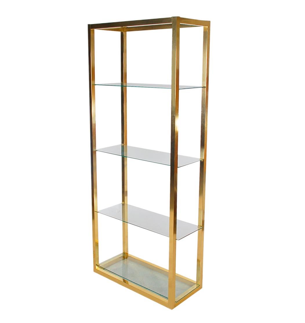 A simple and modern étagère to display your prized possessions. This unit is from the late 1970s or 1980s and is probably Italian. It features brass plating with clear glass shelves.
