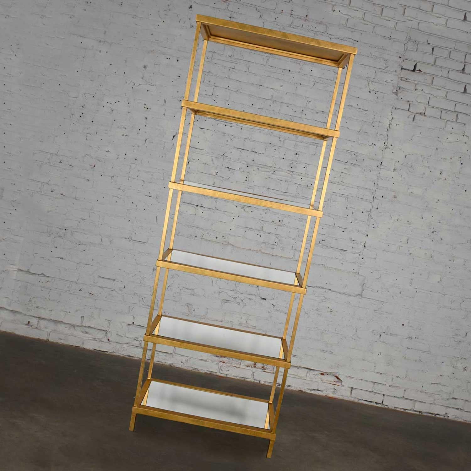 Gorgeous Hollywood Regency or Modern style Chelsea House gold finished iron tall etagere with six mirrored shelves. Beautiful condition, keeping in mind that this is vintage and not new so will have signs of use and wear. Please see photos and zoom