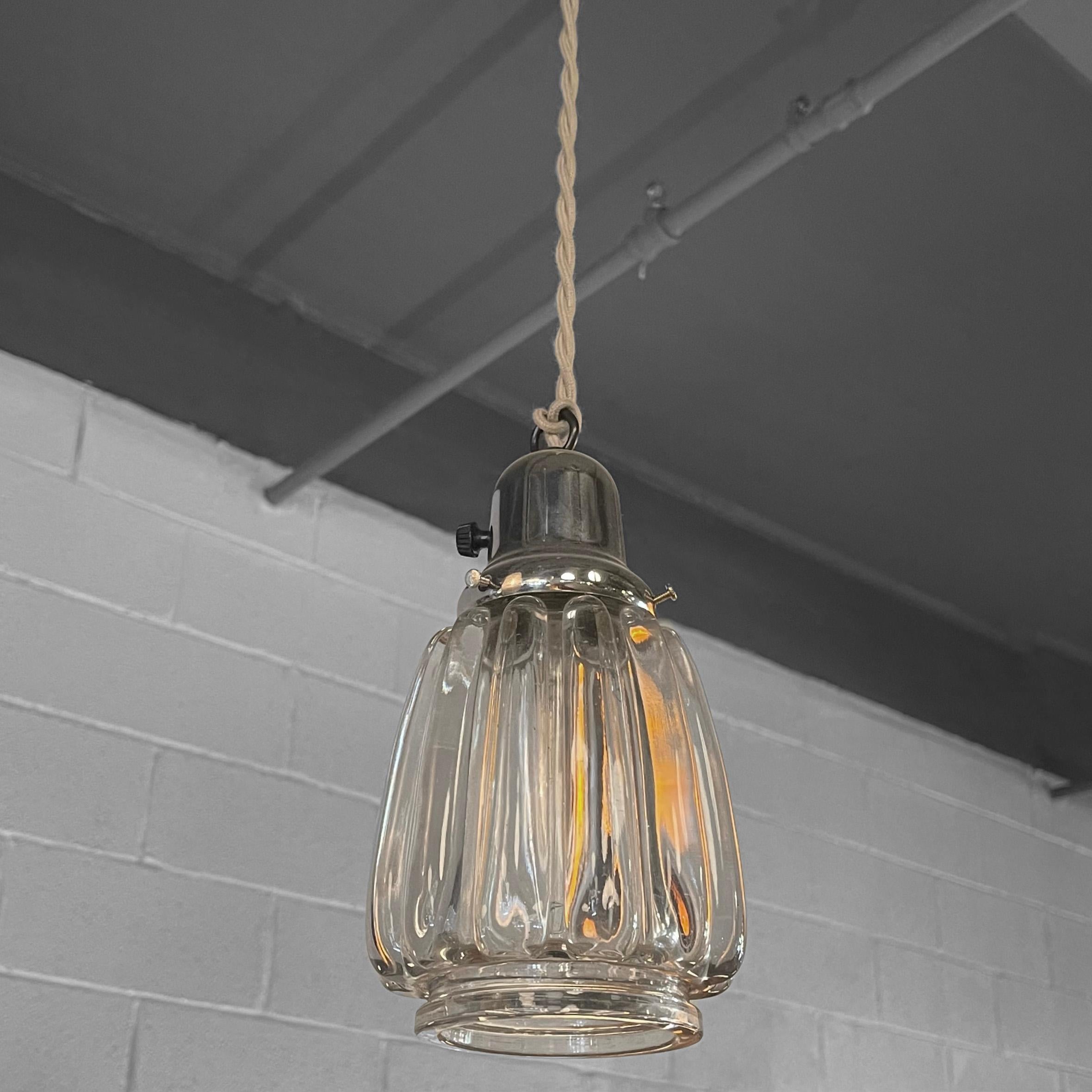 Midcentury, Hollywood Regency, pendant light features an open, molded glass shade with chrome, paddle switch fitter. The pendant is newly wired with 40 inches of braided beige cloth cord to accept up to a 75 watt, medium socket bulb.