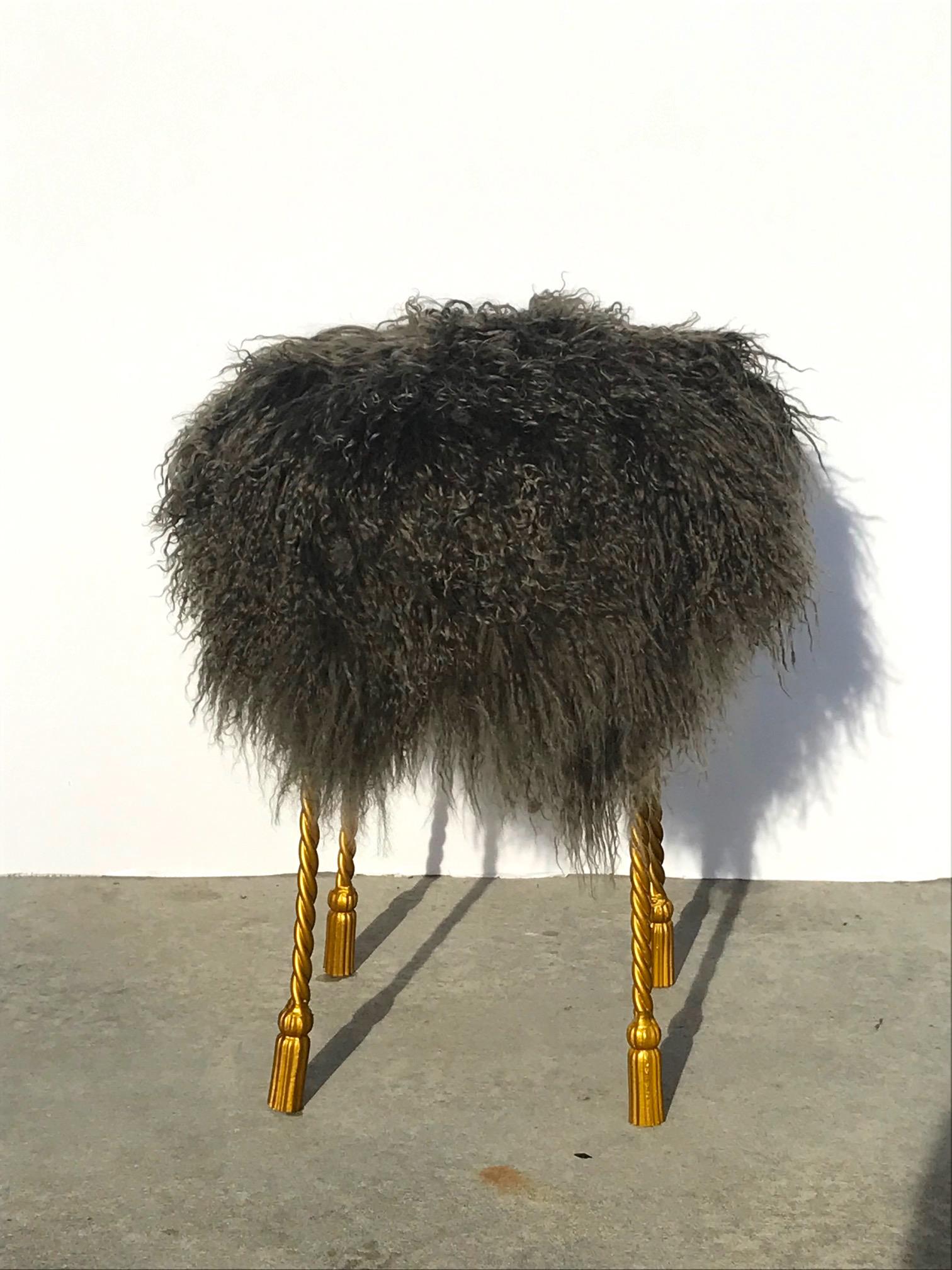 Glamorous Hollywood Regency accent stool or vanity stool. Features wrought iron base with rope design and tassel feet. Hand painted in gold leaf and upholstered in chic Mongolian lamb wool in variant hues somewhere between mushroom and green moss.
